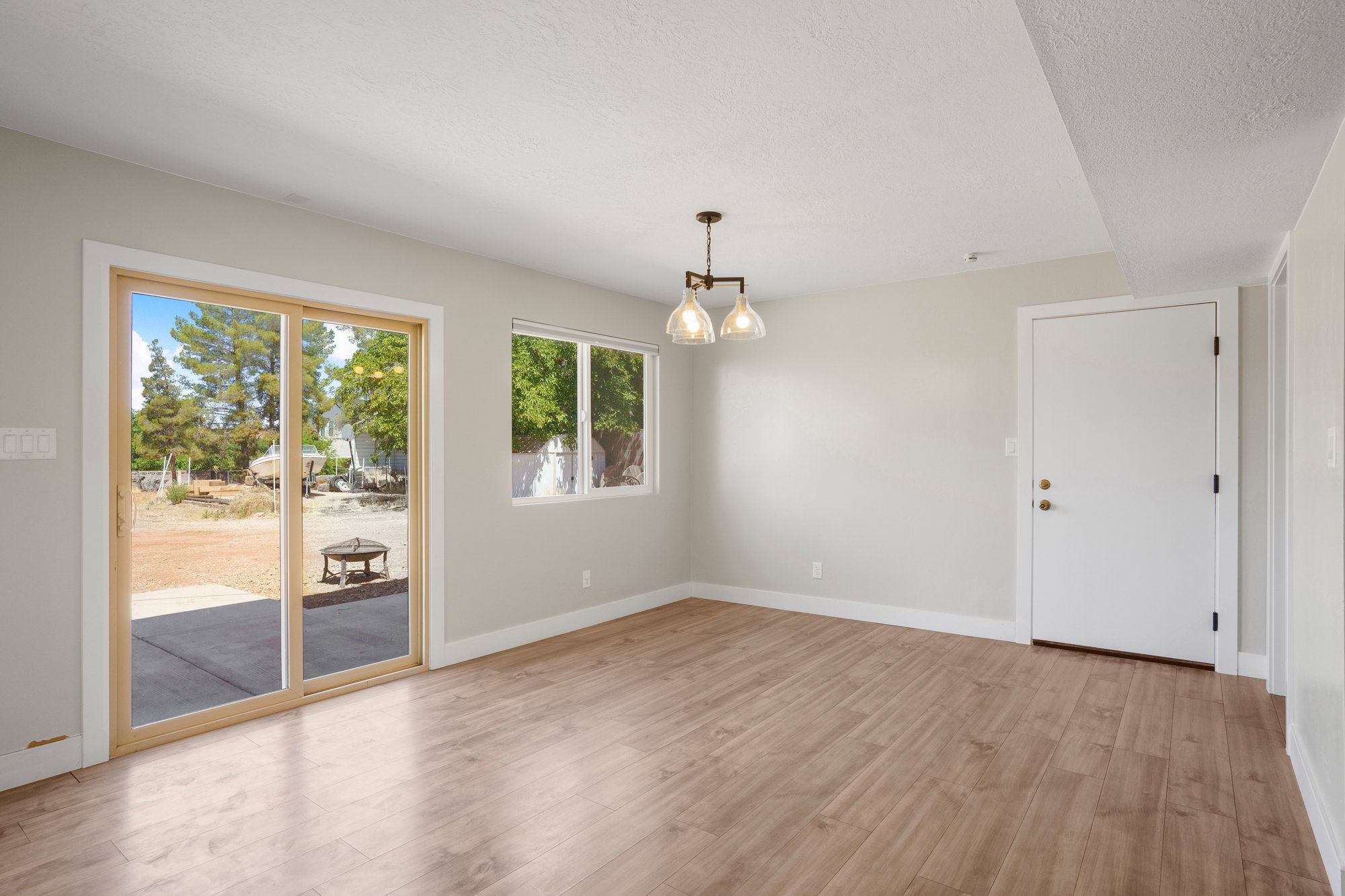 Wood-finish flooring throughout, featuring a sliding glass door with exterior access