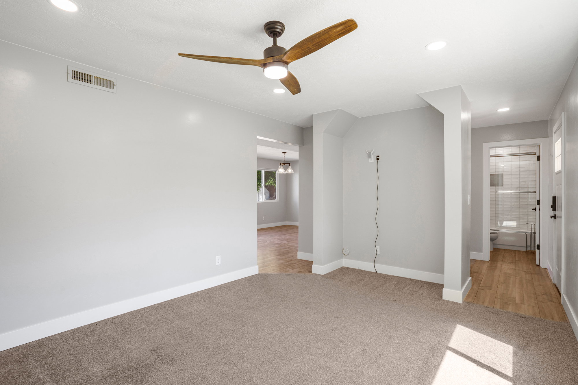 Carpeted room with recessed lighting and a ceiling fan