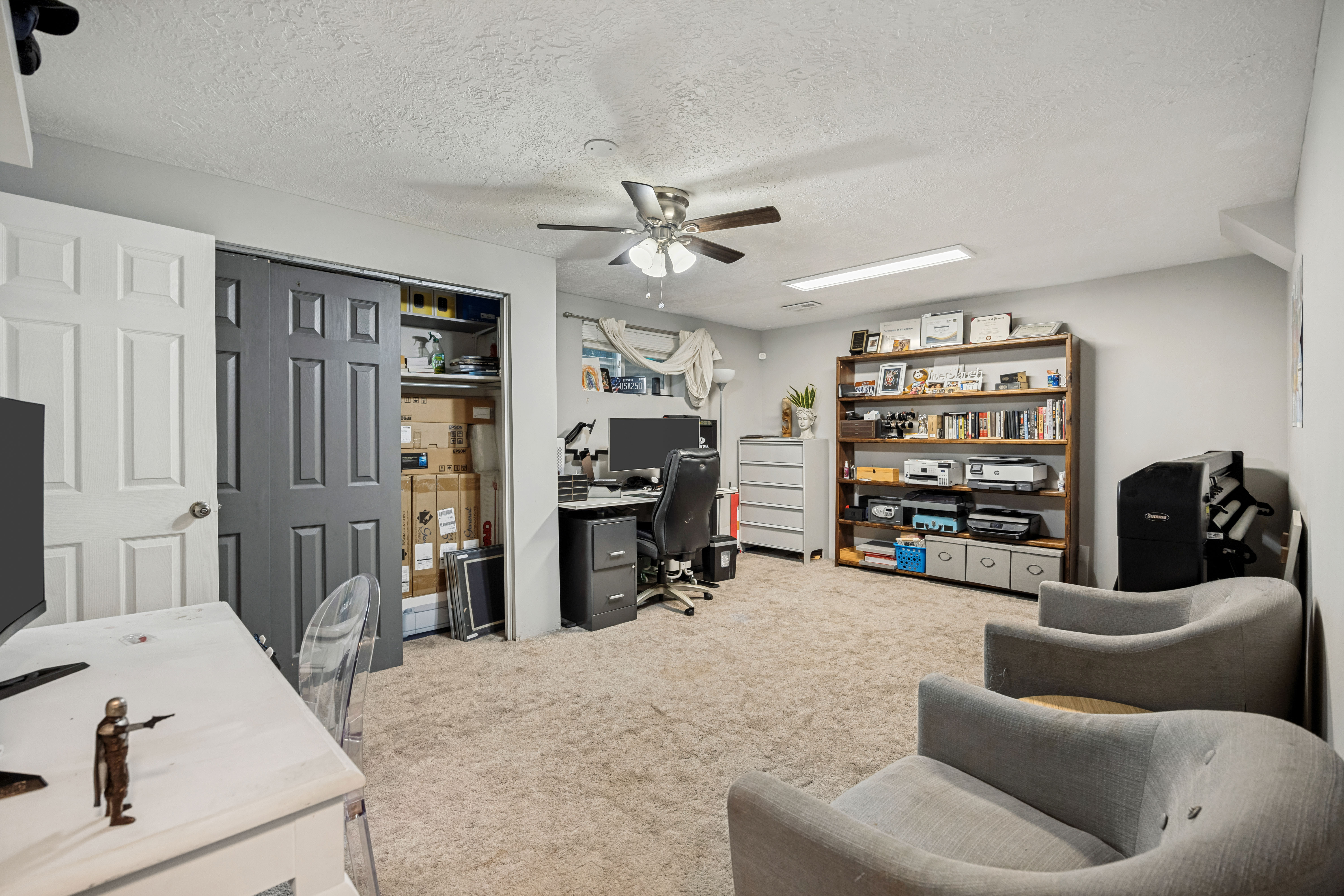 Spacious room featuring neutral carpeting and light-colored walls