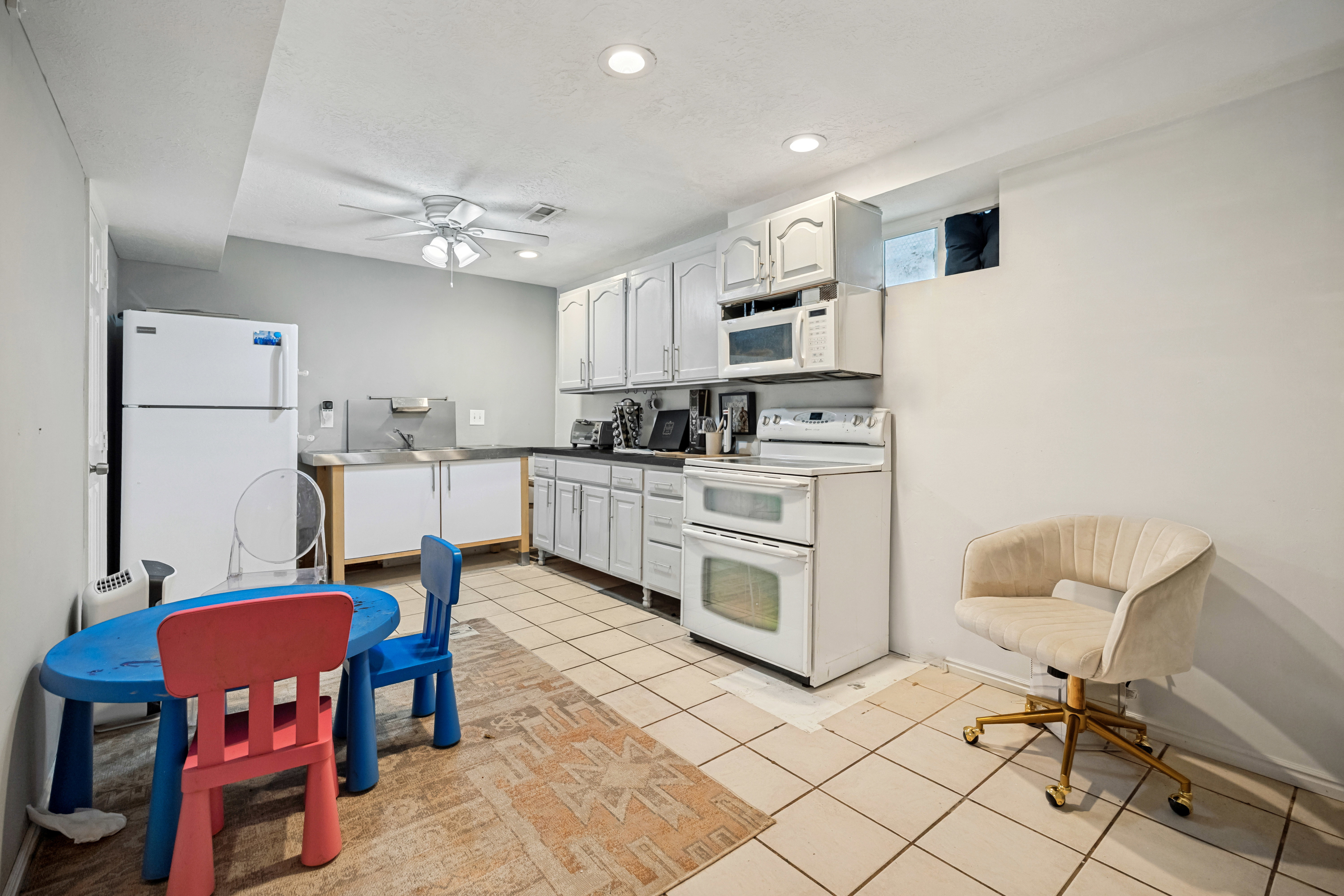 Kitchenette featuring white cabinetry, a white refrigerator, a double oven range, and an over-the-range microwave