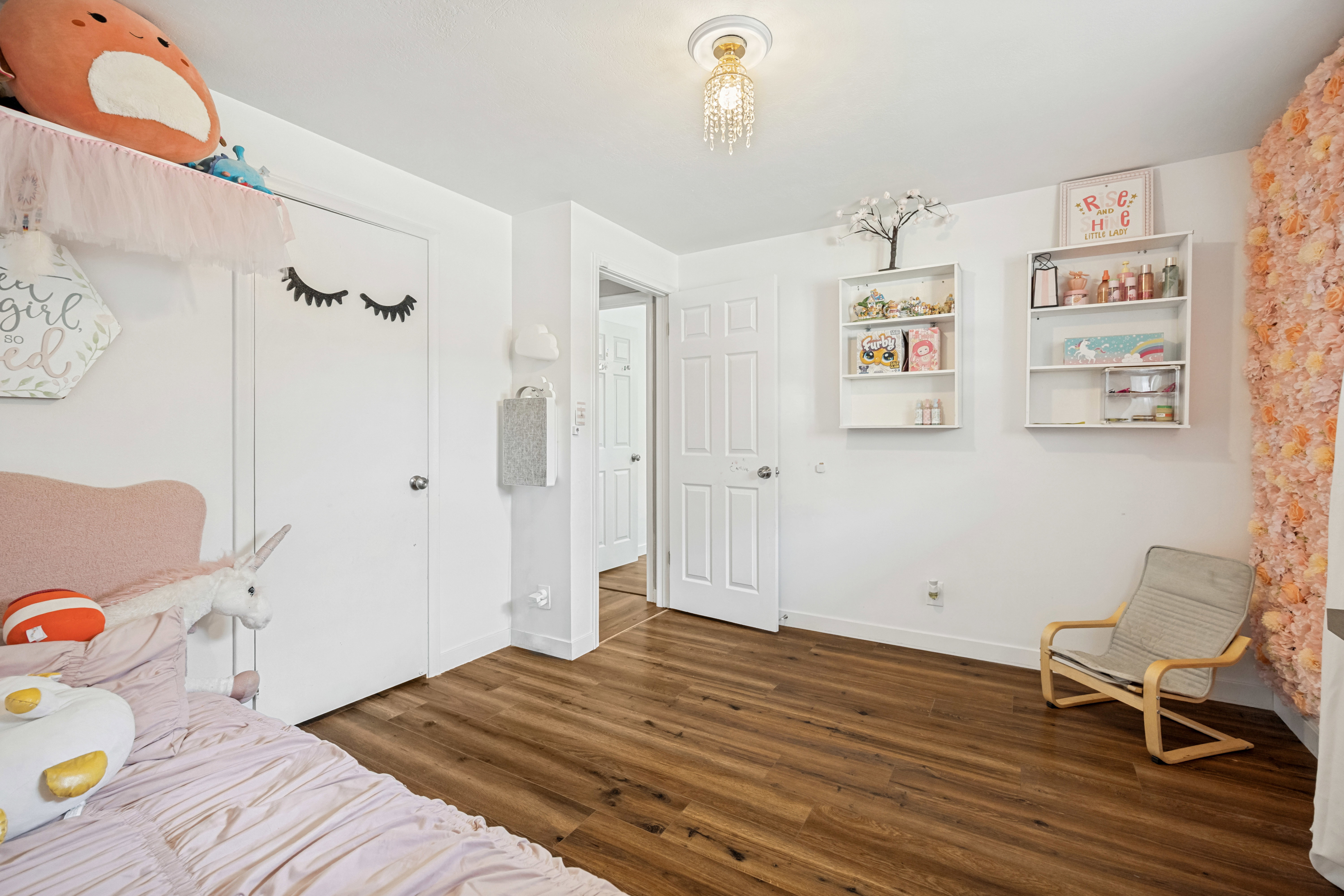 Wood-finish flooring throughout, white baseboards, and white walls