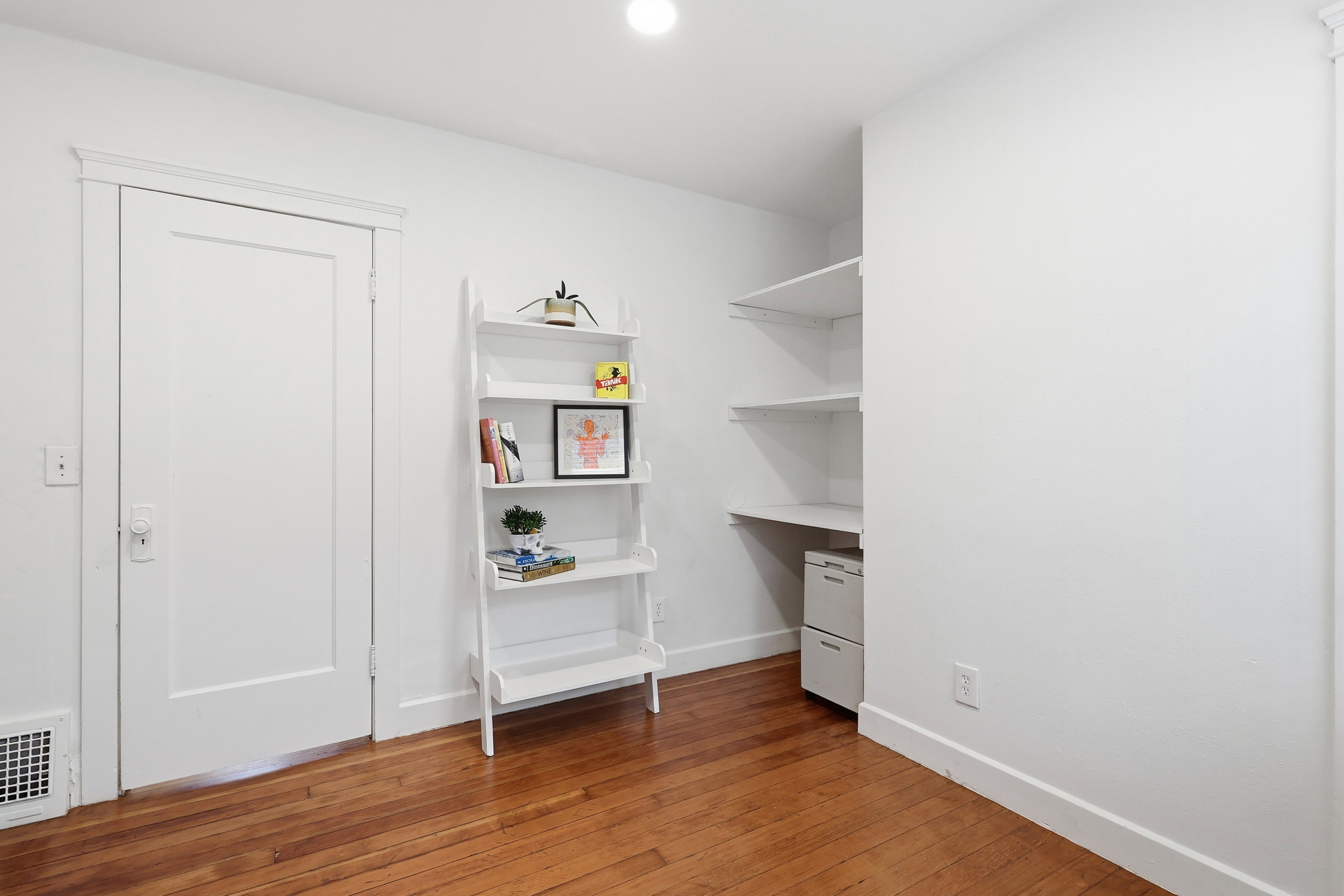 Hardwood flooring complemented by white trim and neutral wall finishes