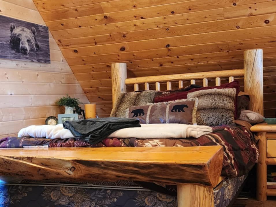 Wood-paneled sloped ceiling and walls highlight this room's architectural character