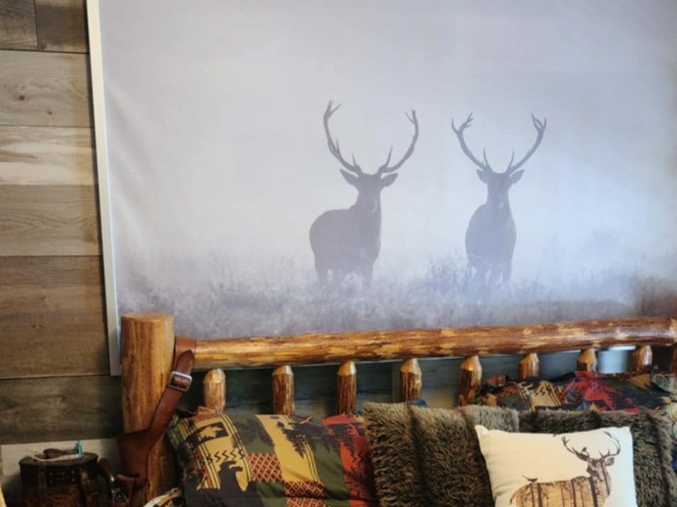 Rustic wood-finish paneling complements a log-style bed frame