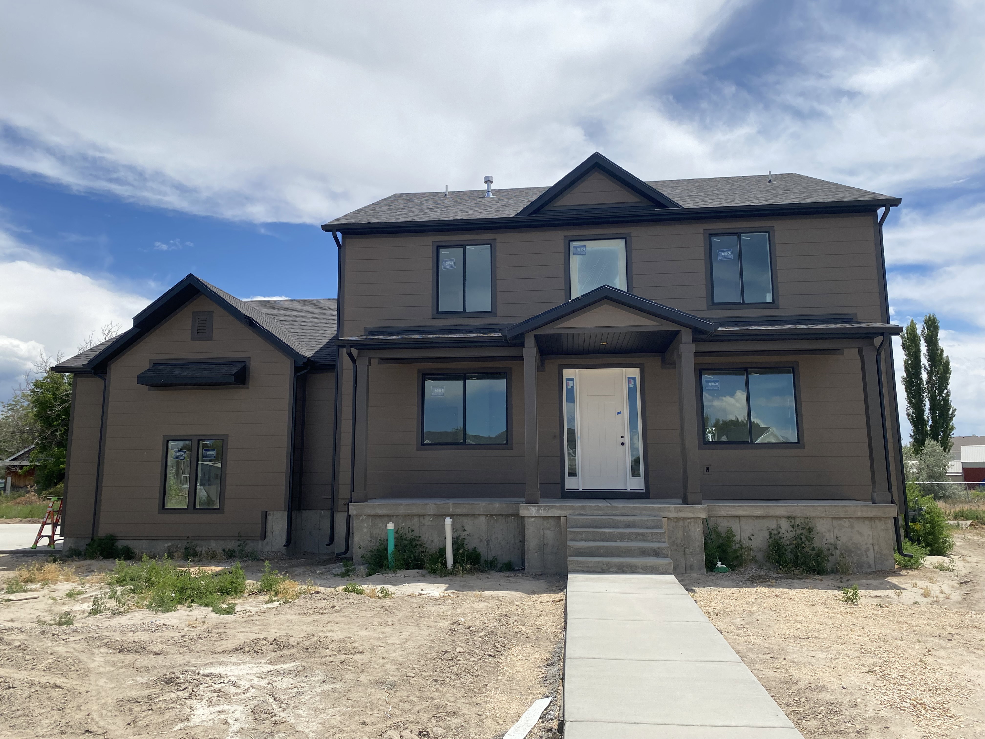 Contemporary exterior with brown siding and dark trim