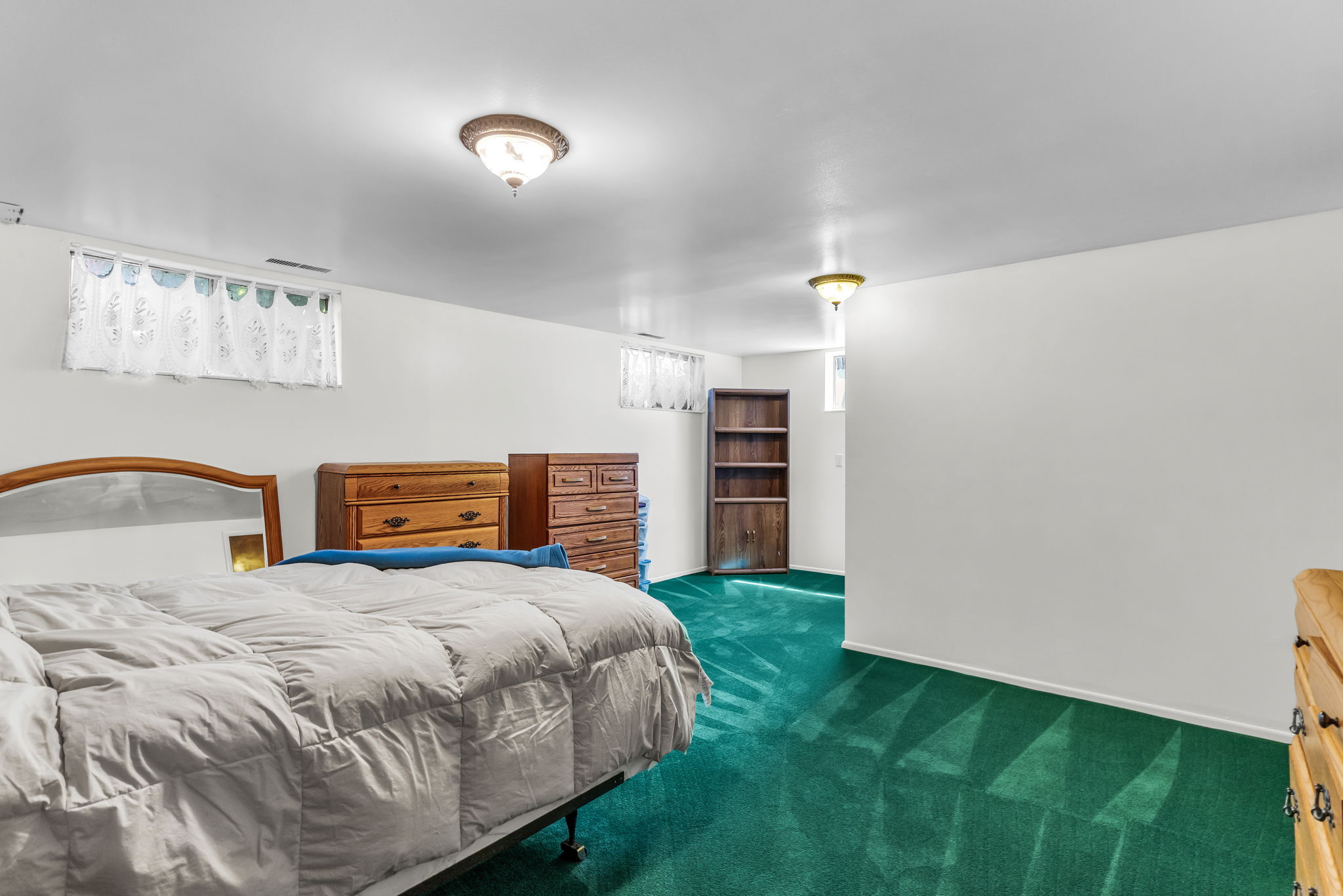 Recessed windows with decorative valances, bright overhead lighting, and white wall finishes