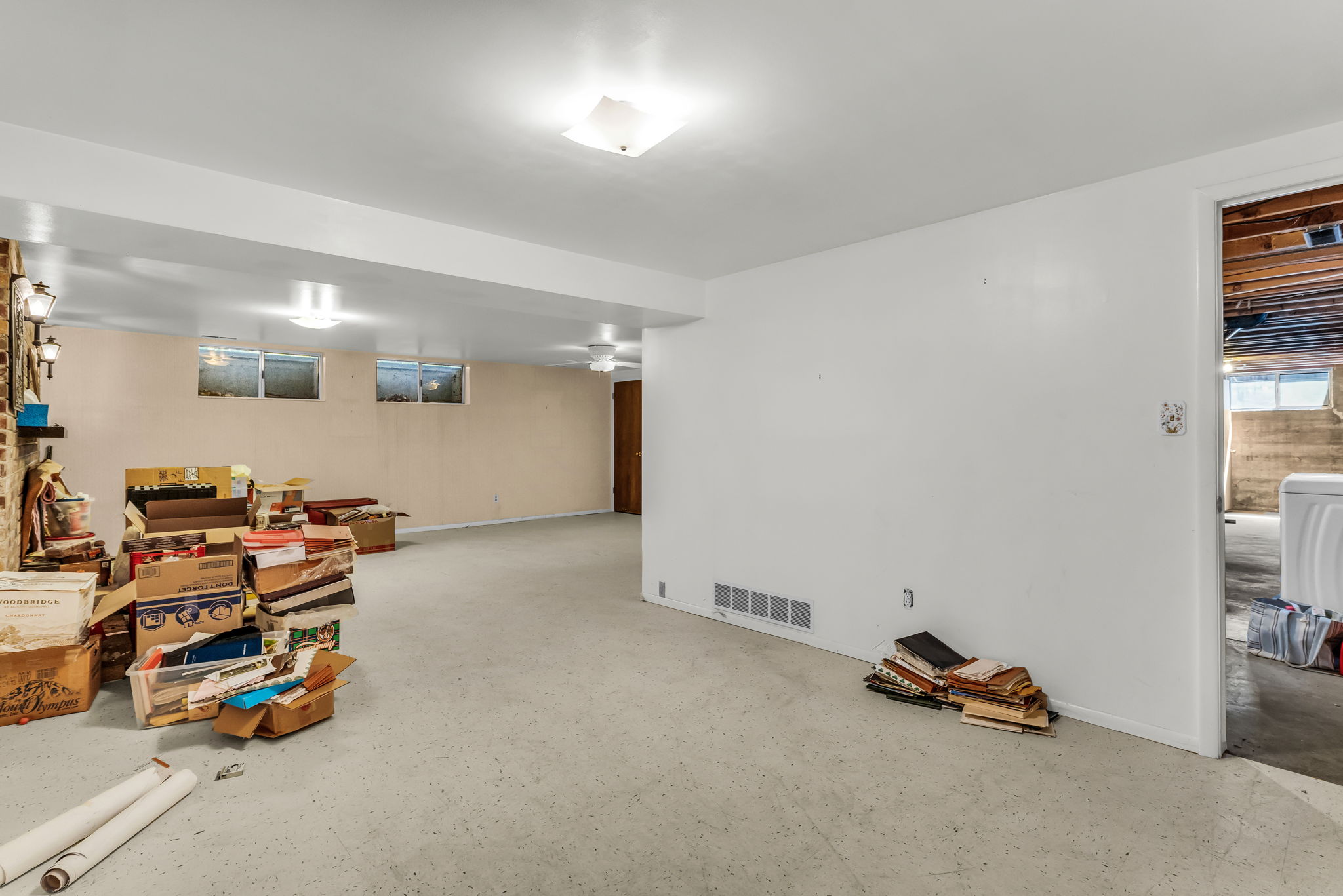 Spacious lower level offering a large open area, recessed lighting, and a partial brick wall accent