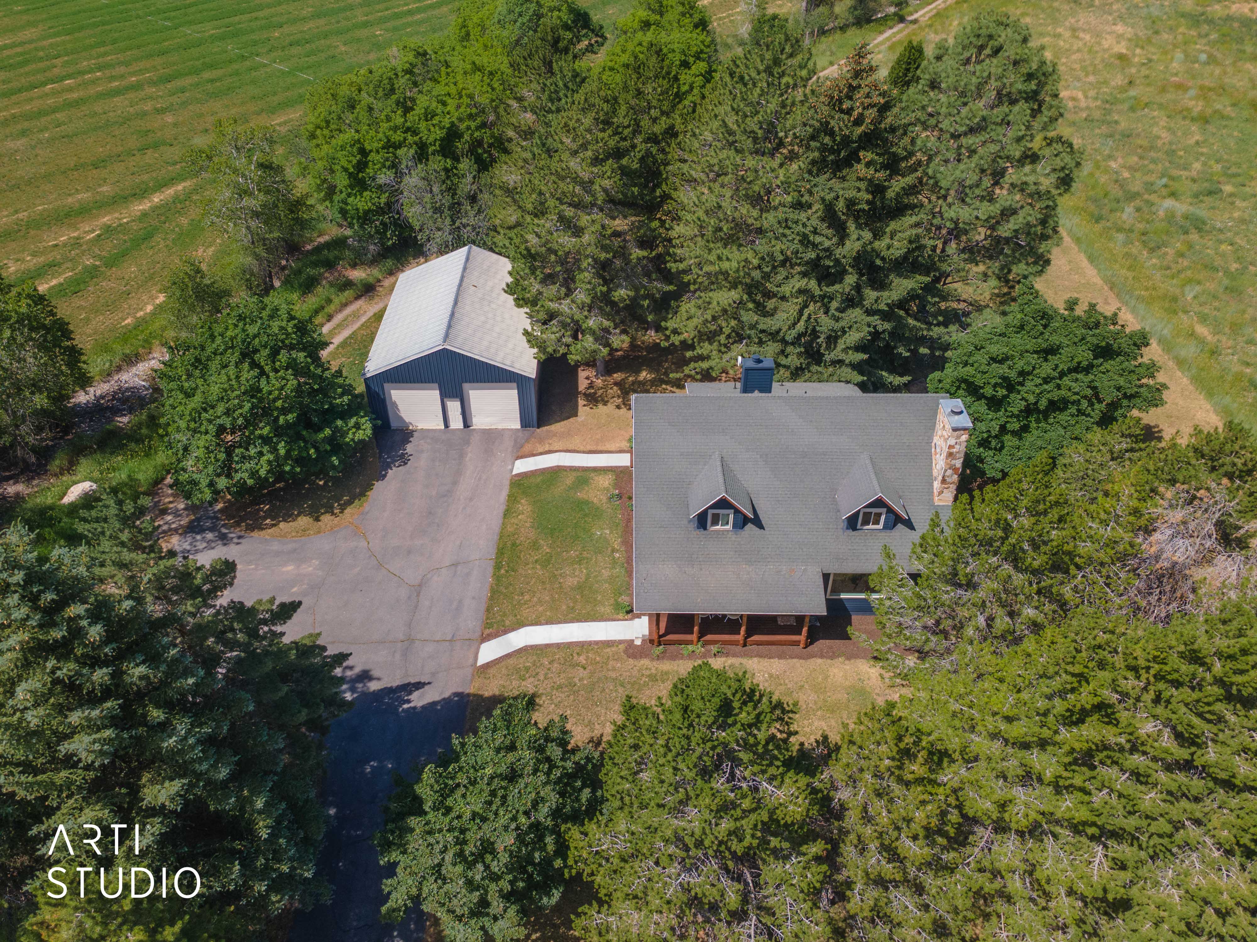 Aerial perspective showcasing a property surrounded by mature trees