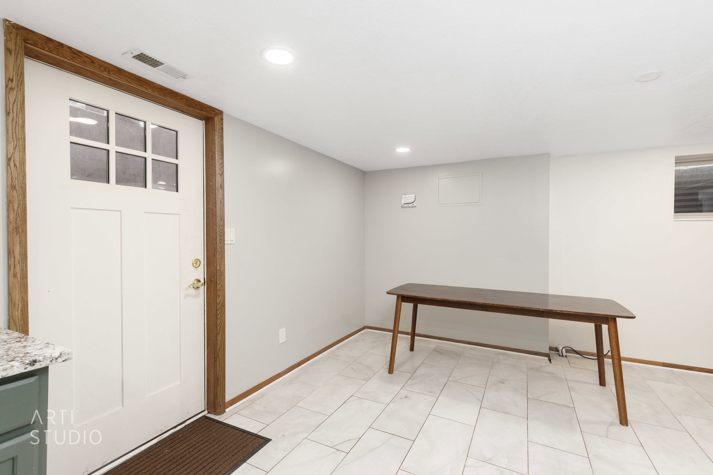 Entryway featuring a paneled door with upper glass inserts and natural wood trim