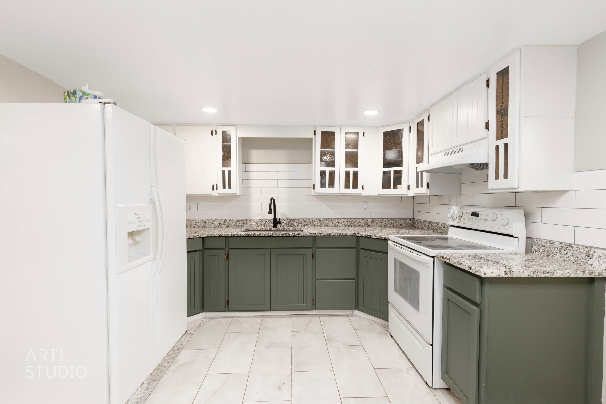Kitchen featuring two-tone cabinetry, light-toned countertops, subway tile backsplash, recessed lighting, and tile flooring