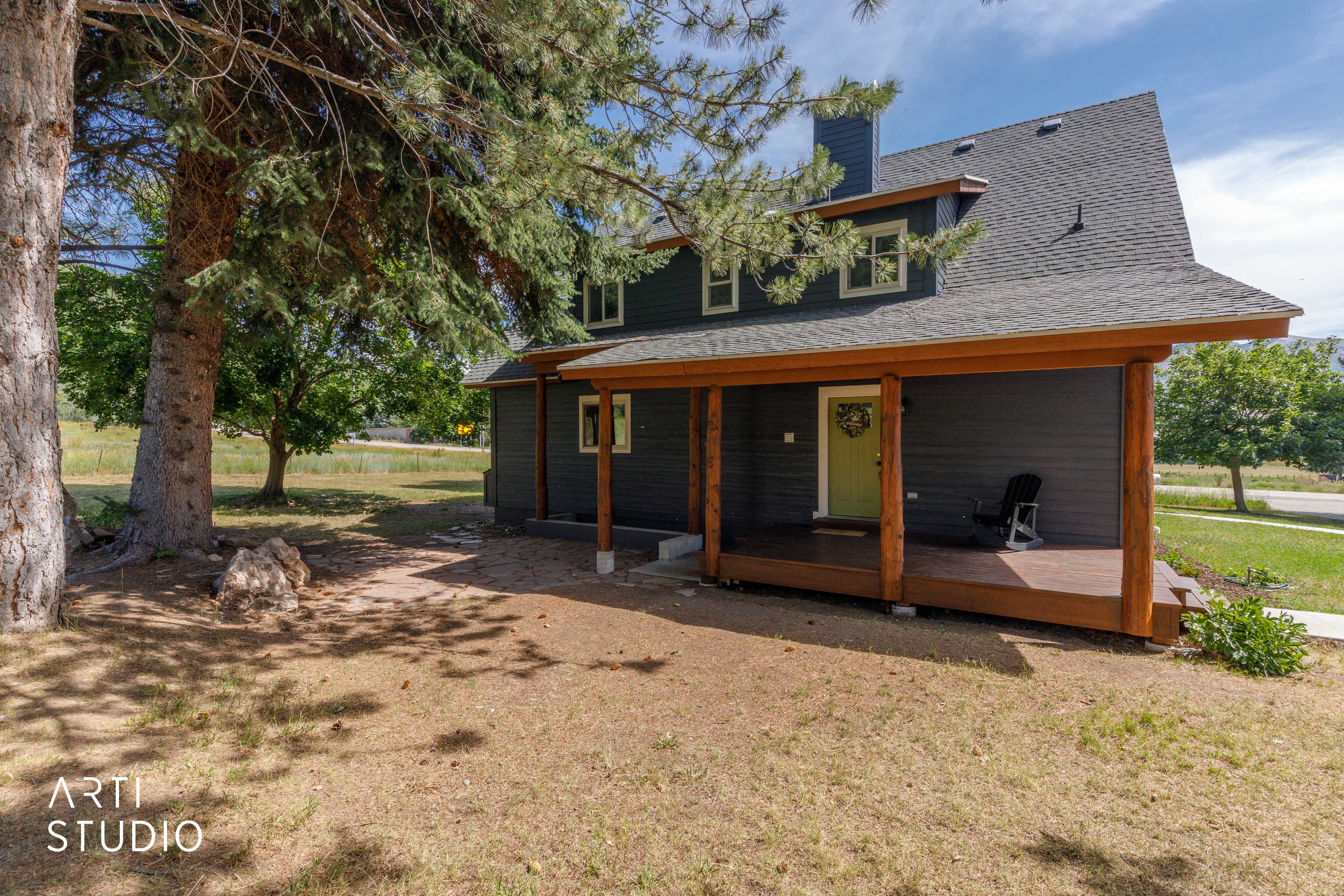 Charcoal siding exterior with a dark shingle roof