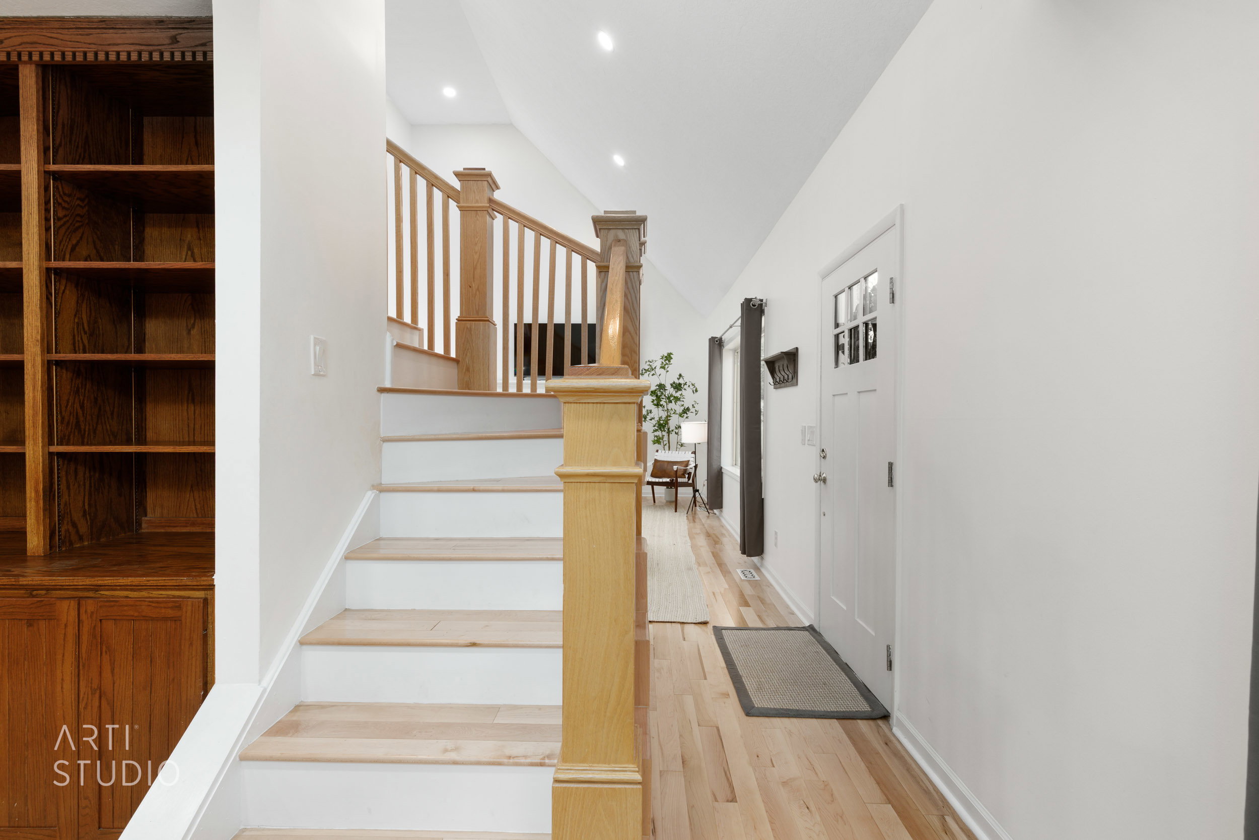 Hardwood flooring throughout the entry, staircase, and hallway