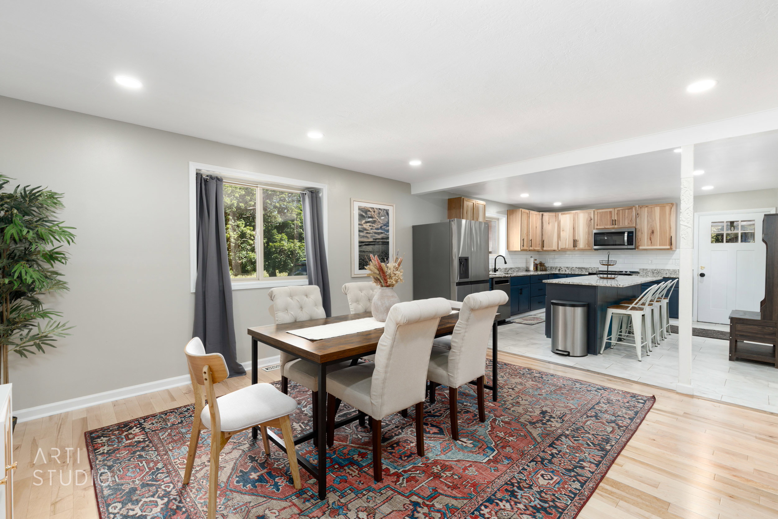 Dining area featuring light wood-finish flooring and recessed lighting