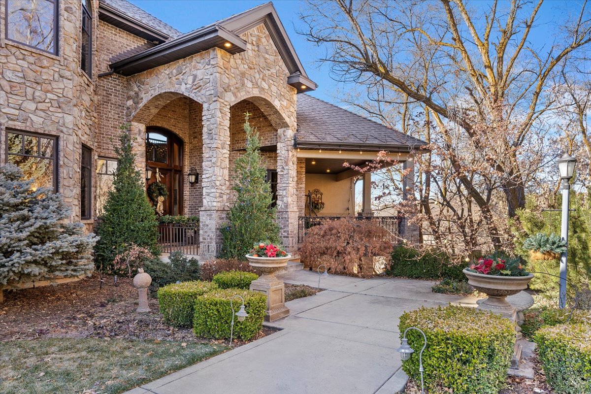 Stone and brick exterior with arched entryway and covered porch