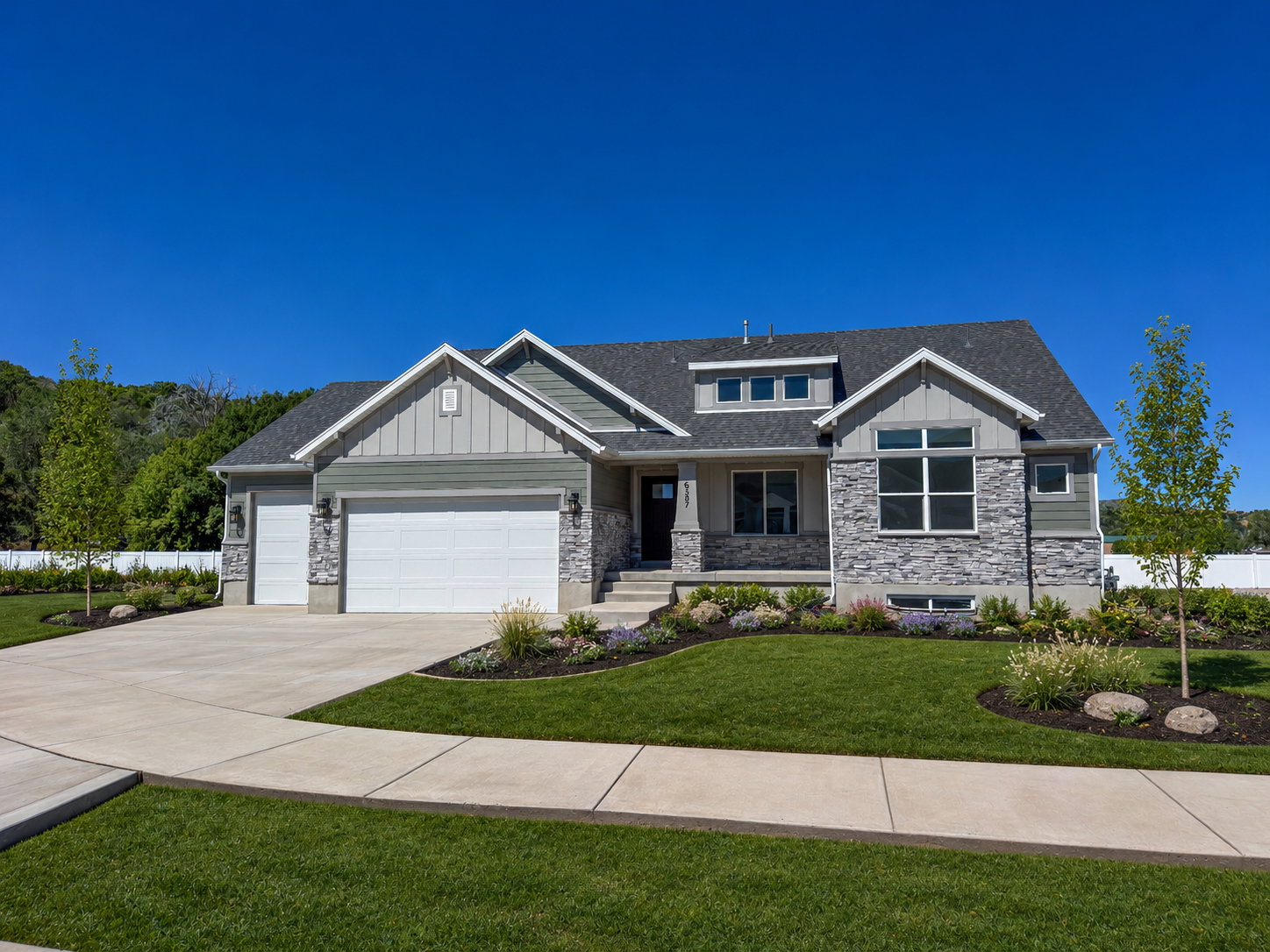 Modern craftsman-style exterior featuring a stone and siding facade