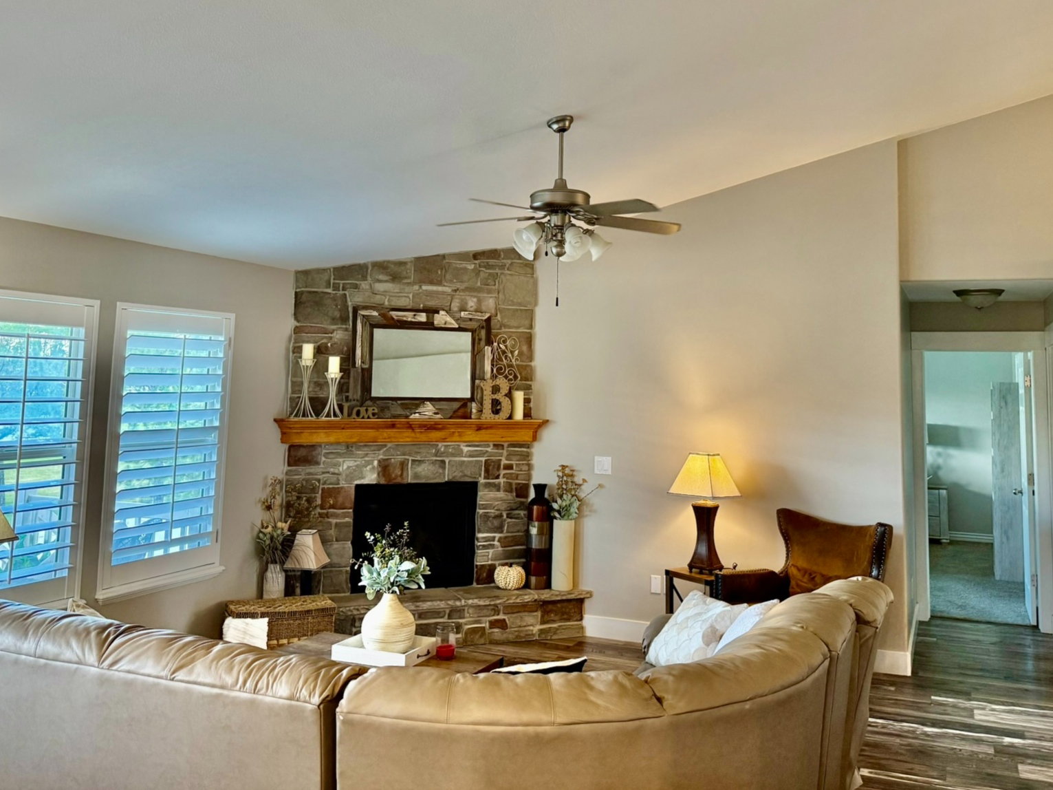 Stacked stone fireplace with a substantial wood mantel