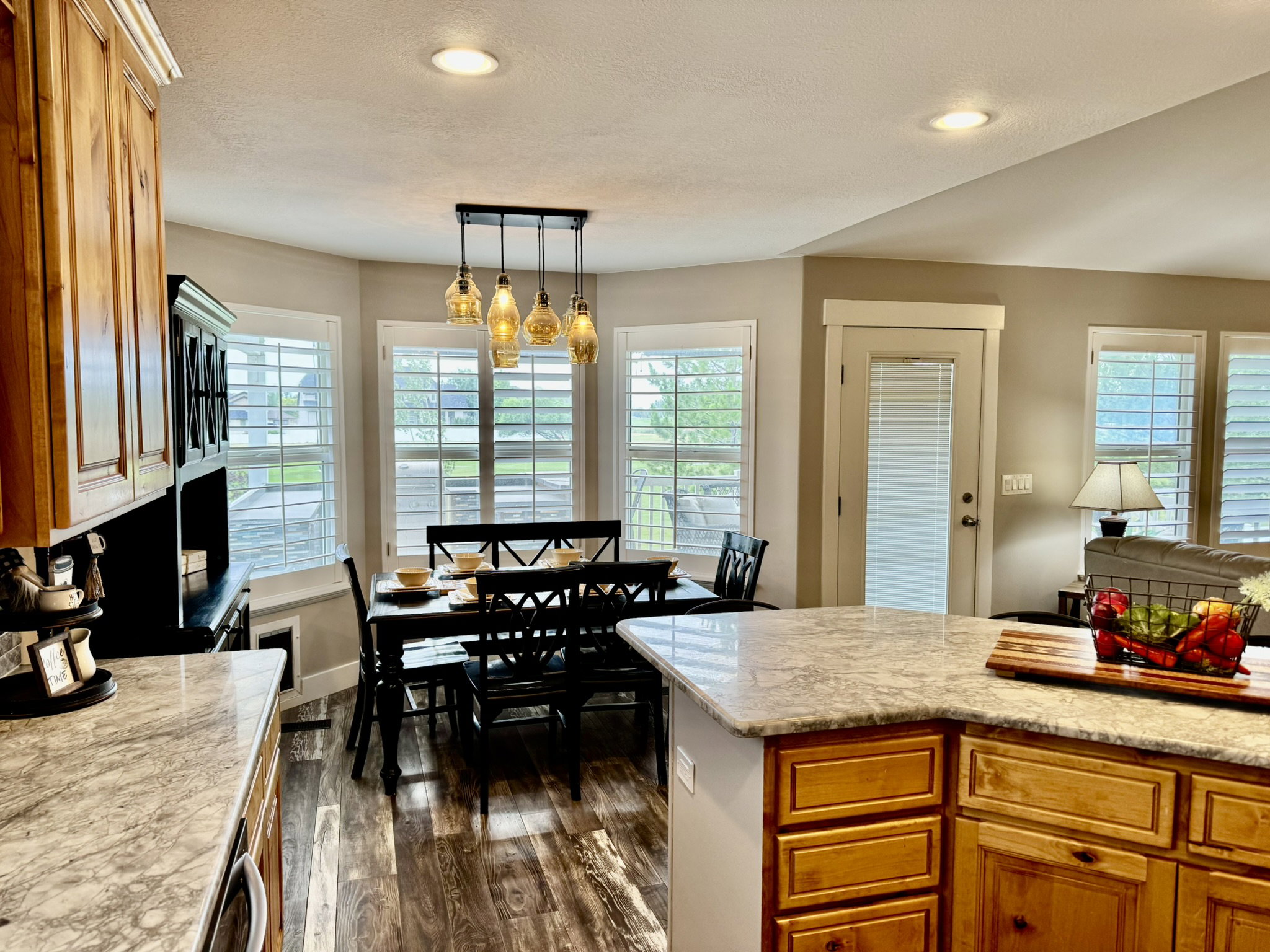 Kitchen and dining area featuring wood-finish flooring