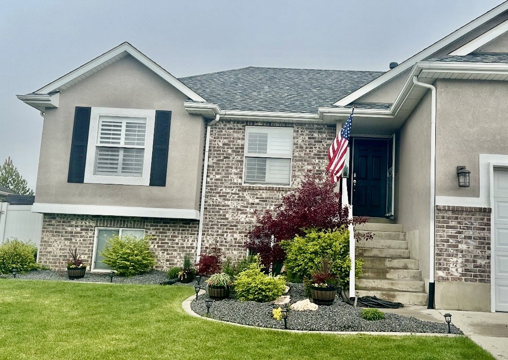 Exterior facade featuring brick accents and stucco siding