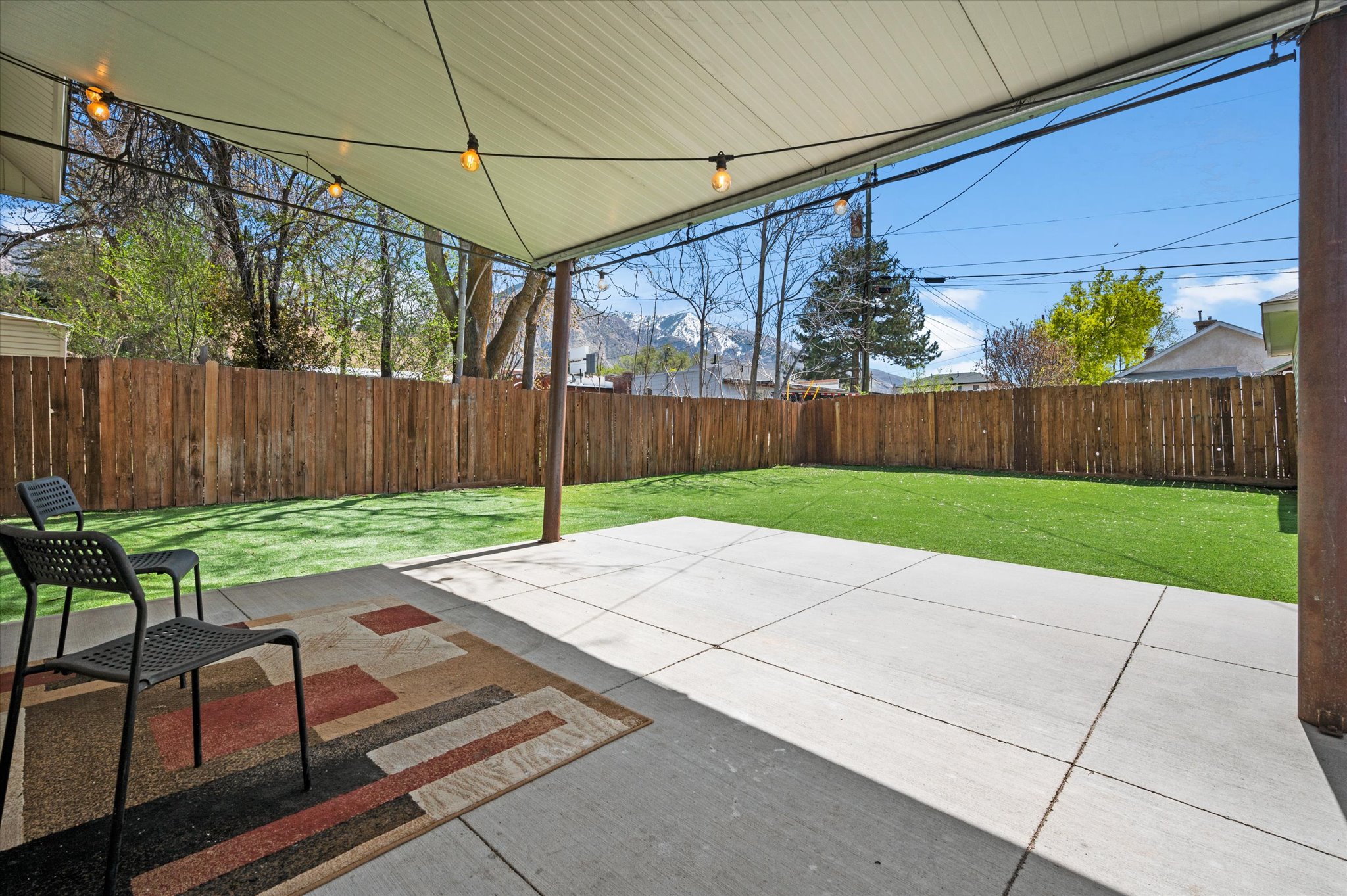 Covered patio featuring string lights