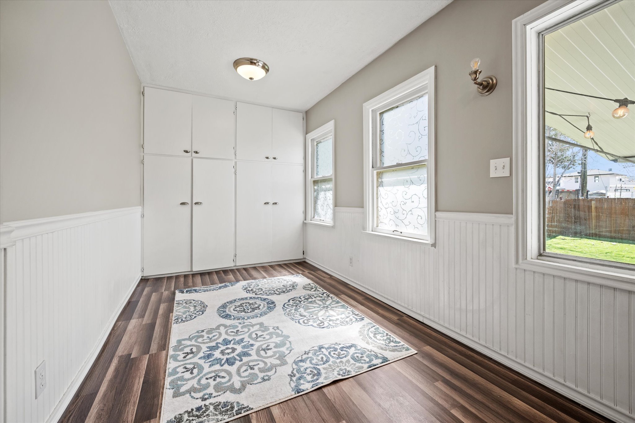 Wood-finish flooring complemented by white wainscoting