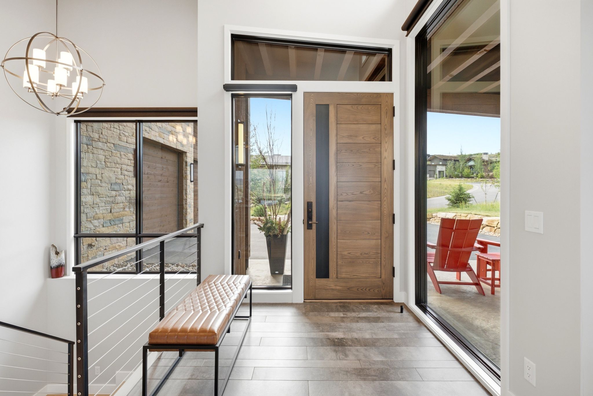 Entryway featuring a solid wood front door with a vertical glass insert, wood-finish flooring, and a large sidelight window
