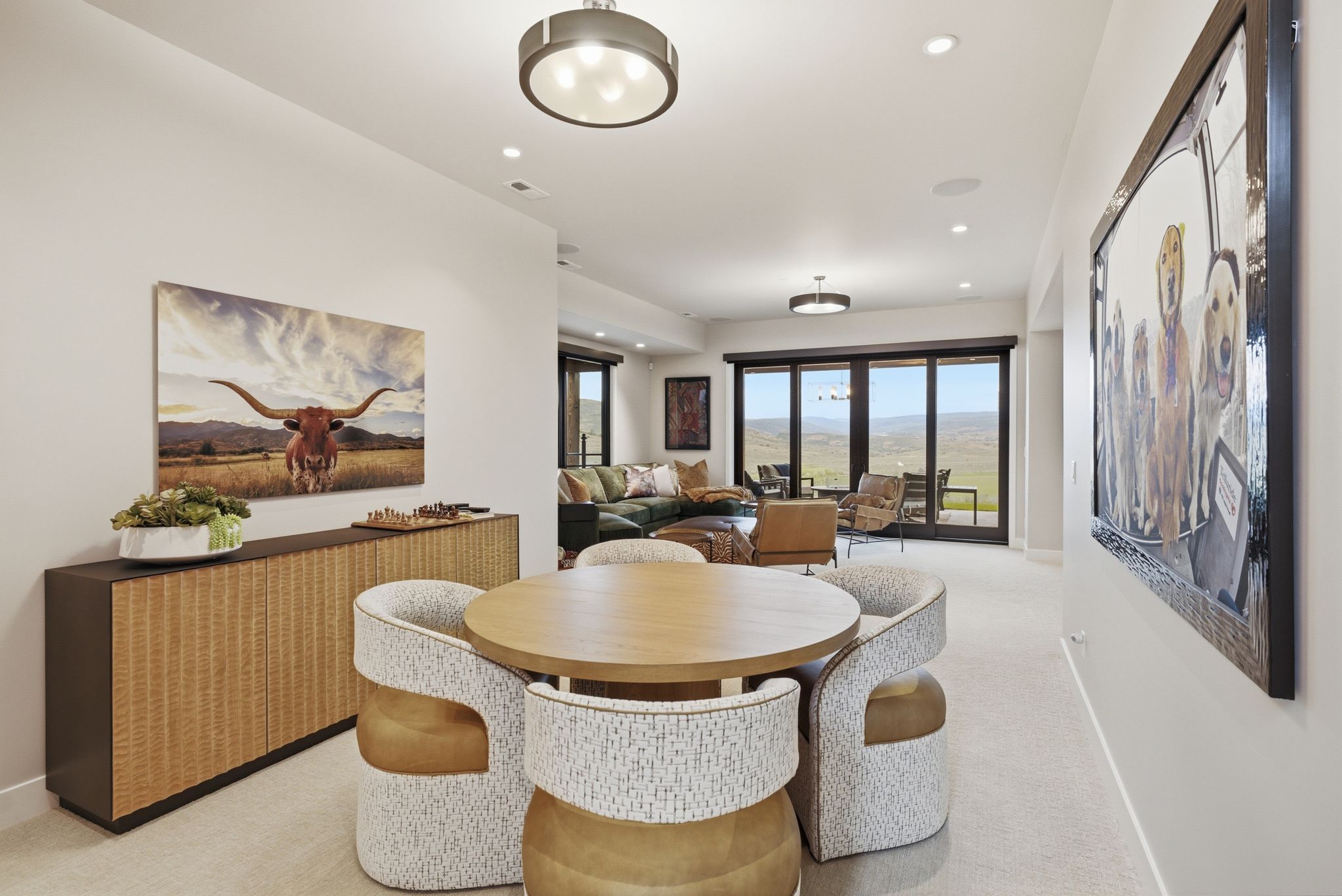 Spacious interior showcasing light-colored carpeting, recessed lighting, and a contemporary ceiling fixture