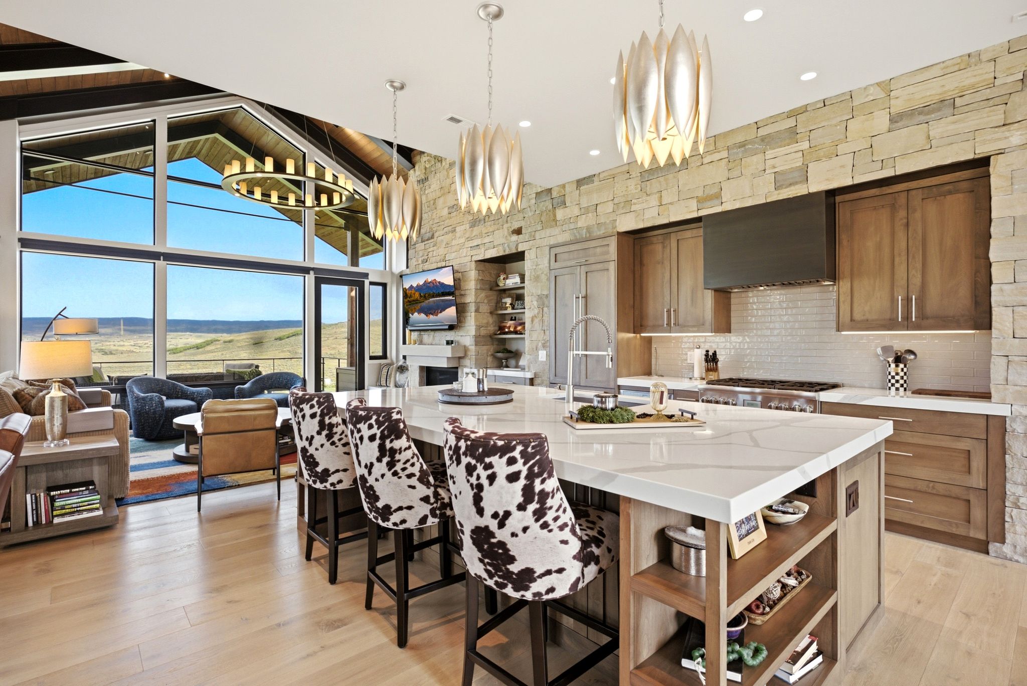 Spacious open-concept living area featuring light wood-finish flooring and vaulted ceilings