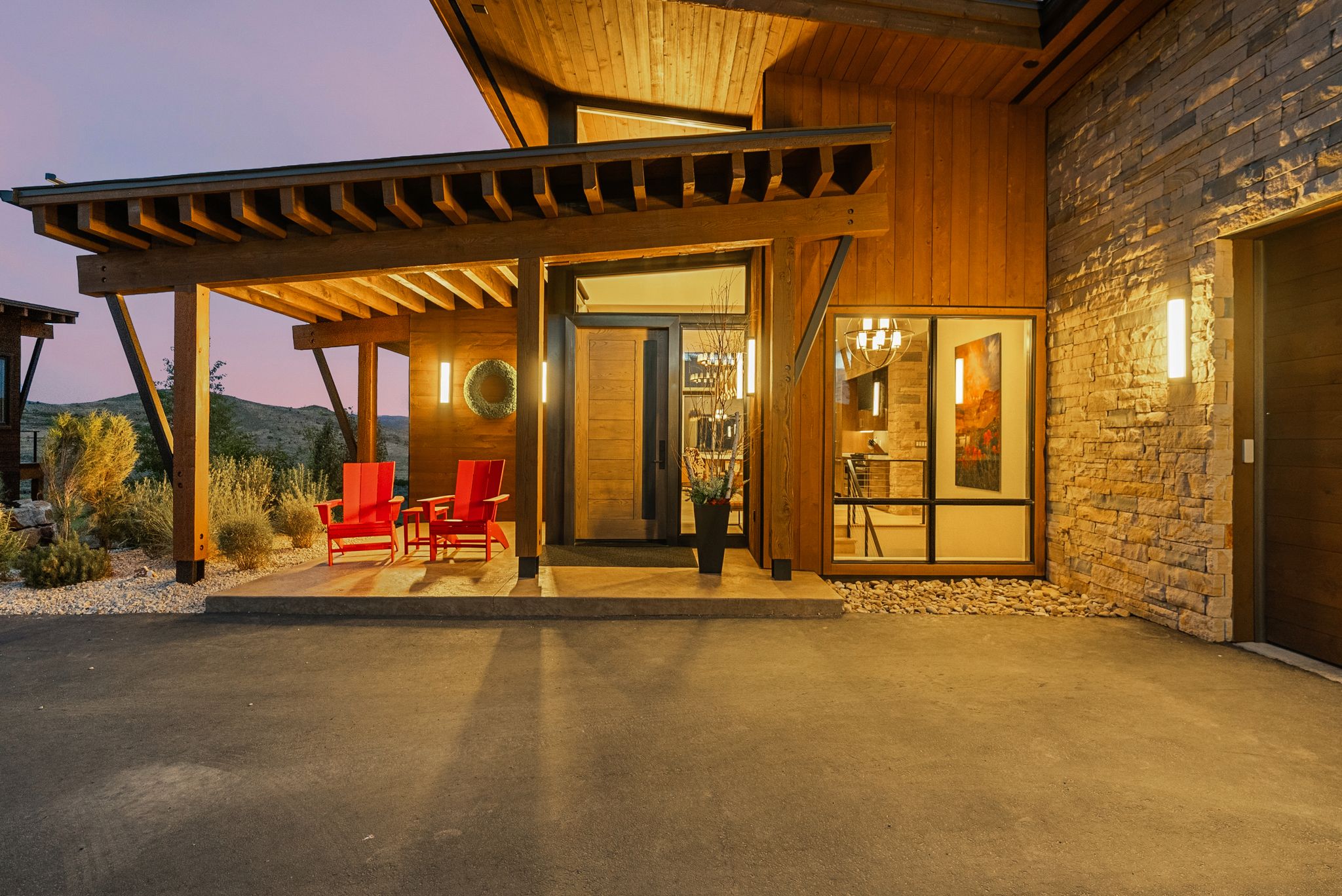 Contemporary architectural facade featuring warm wood siding and stacked stone accents