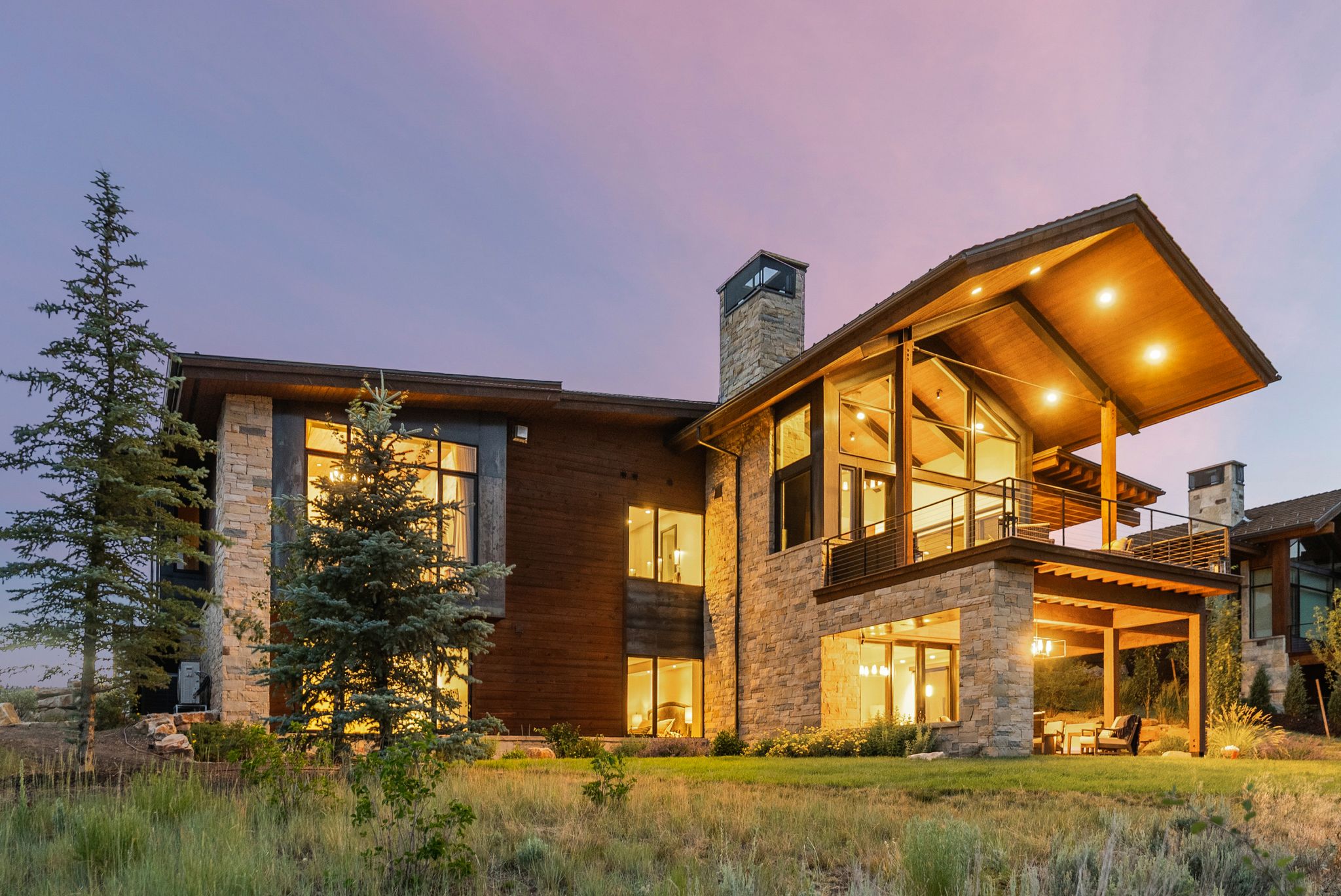 Contemporary multi-level residence featuring stone and wood siding