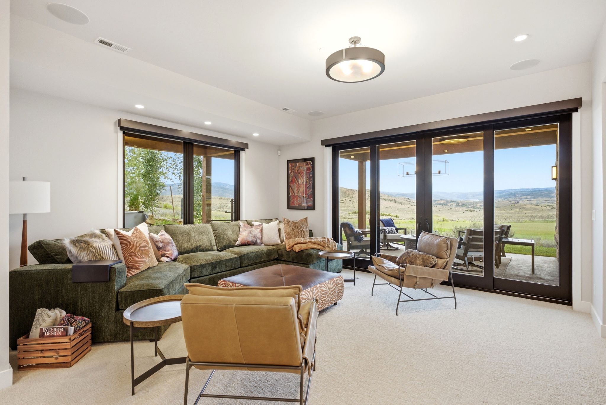 Spacious room featuring expansive glass sliding doors and an additional large window, offering abundant natural light and an outdoor connection