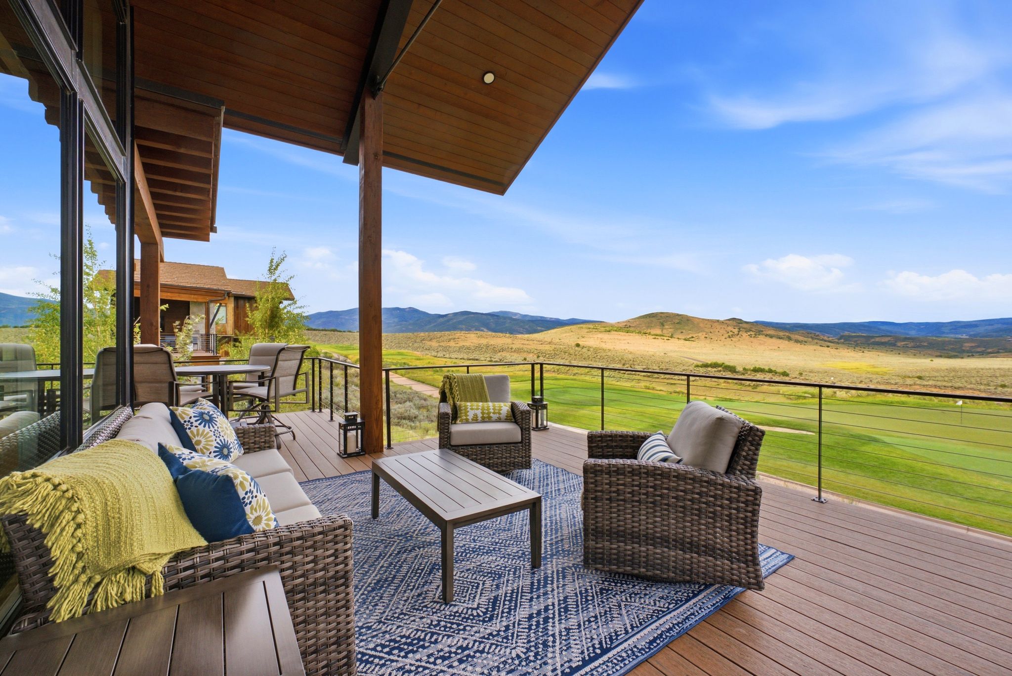 Expansive outdoor deck featuring wood-finish decking and a glass railing system