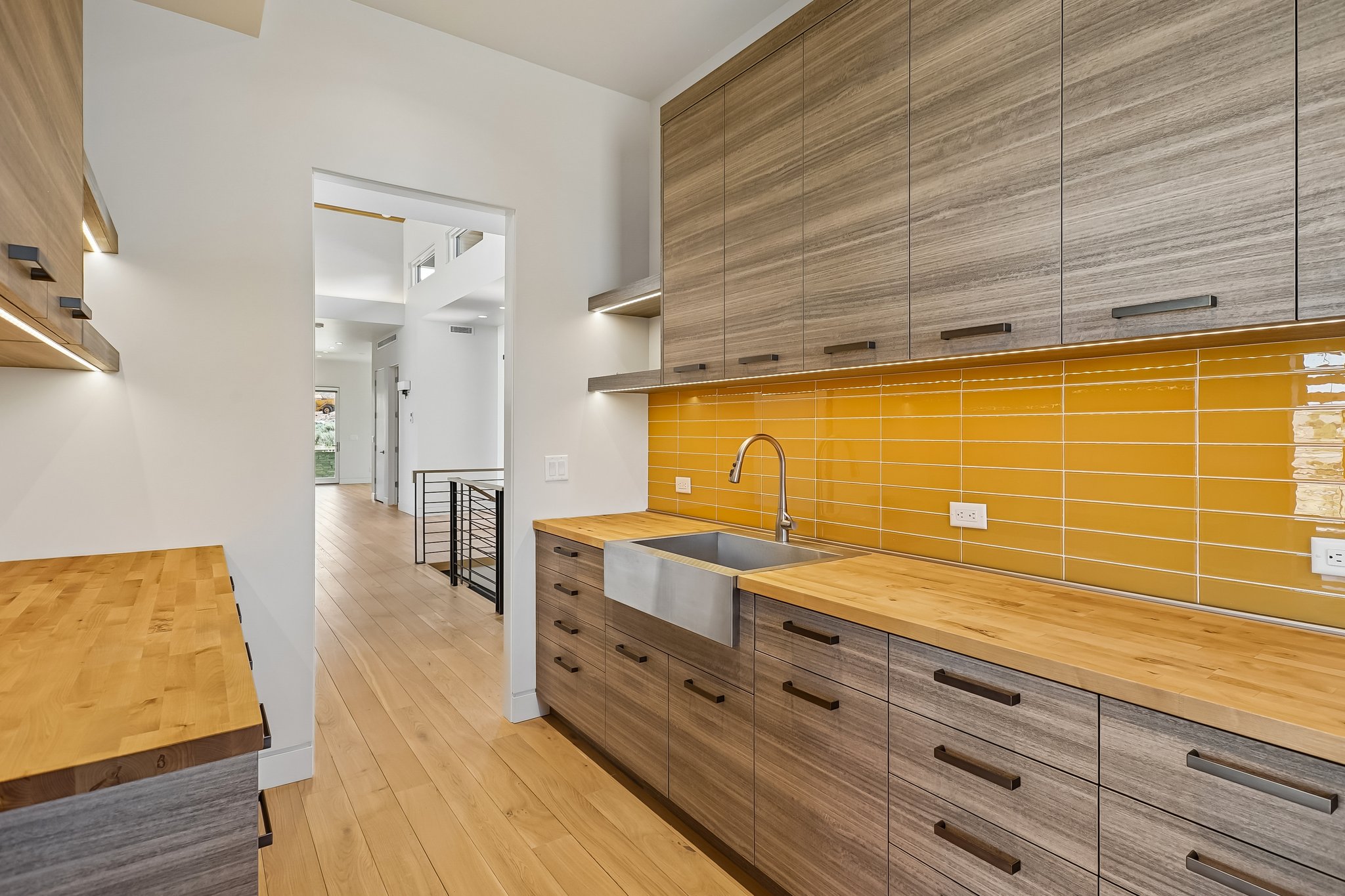 Modern kitchen space featuring light wood-finish flooring