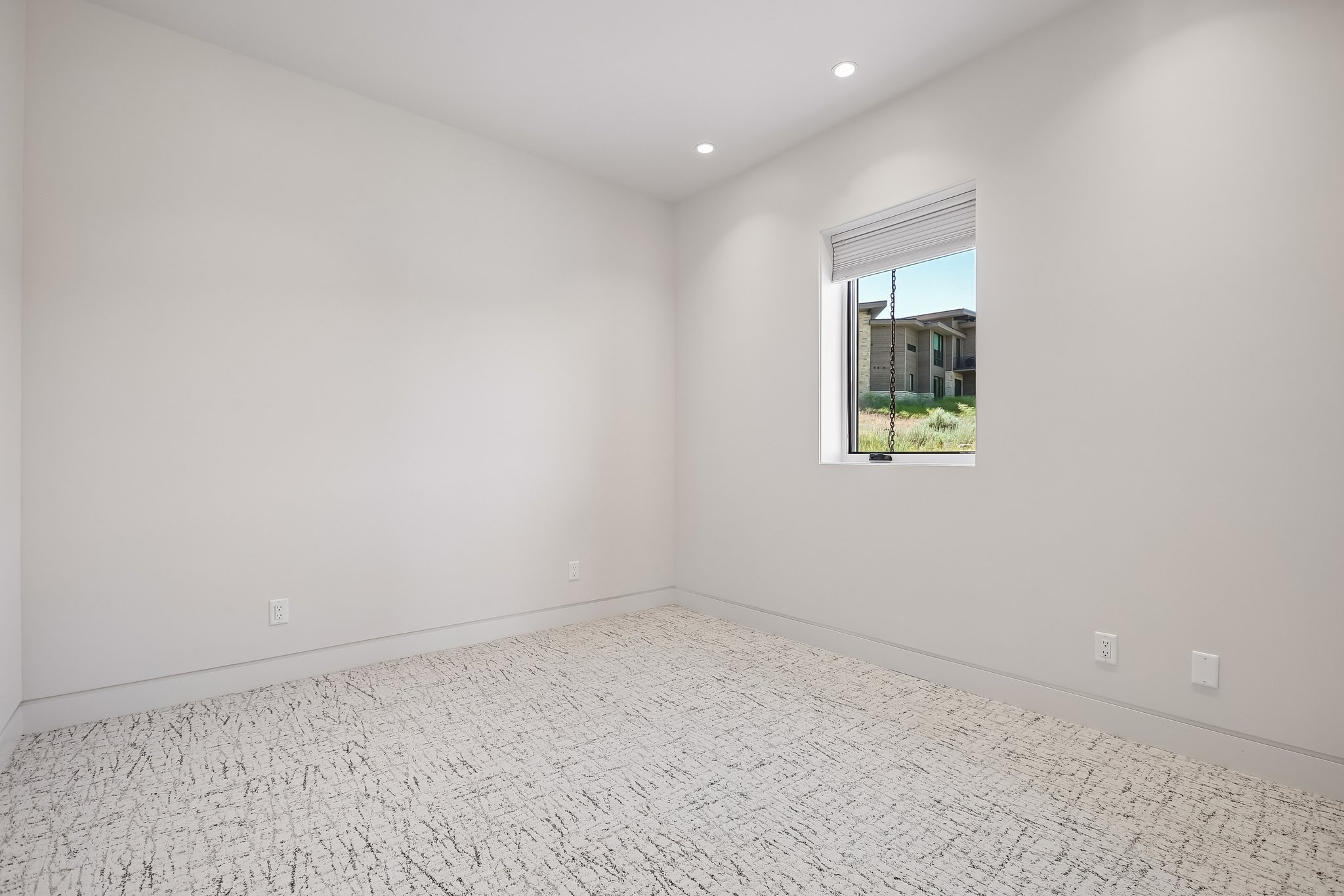 Room featuring a single window, recessed lighting, and patterned carpet flooring