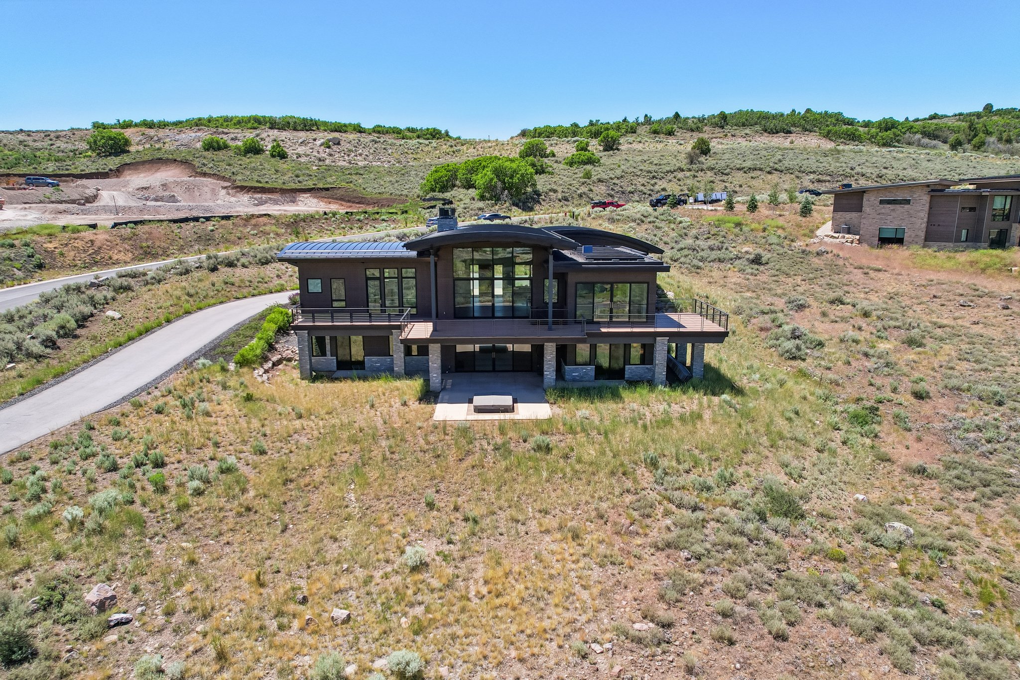 Contemporary architecture featuring dark siding and natural stone accents