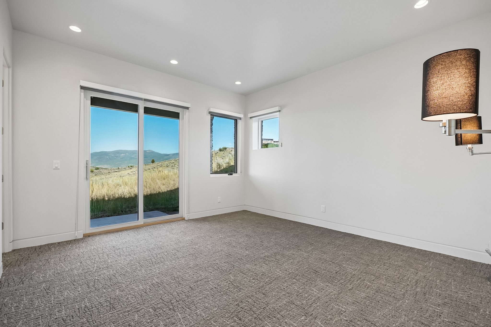 Sliding glass door leading to outdoor space, complemented by additional windows