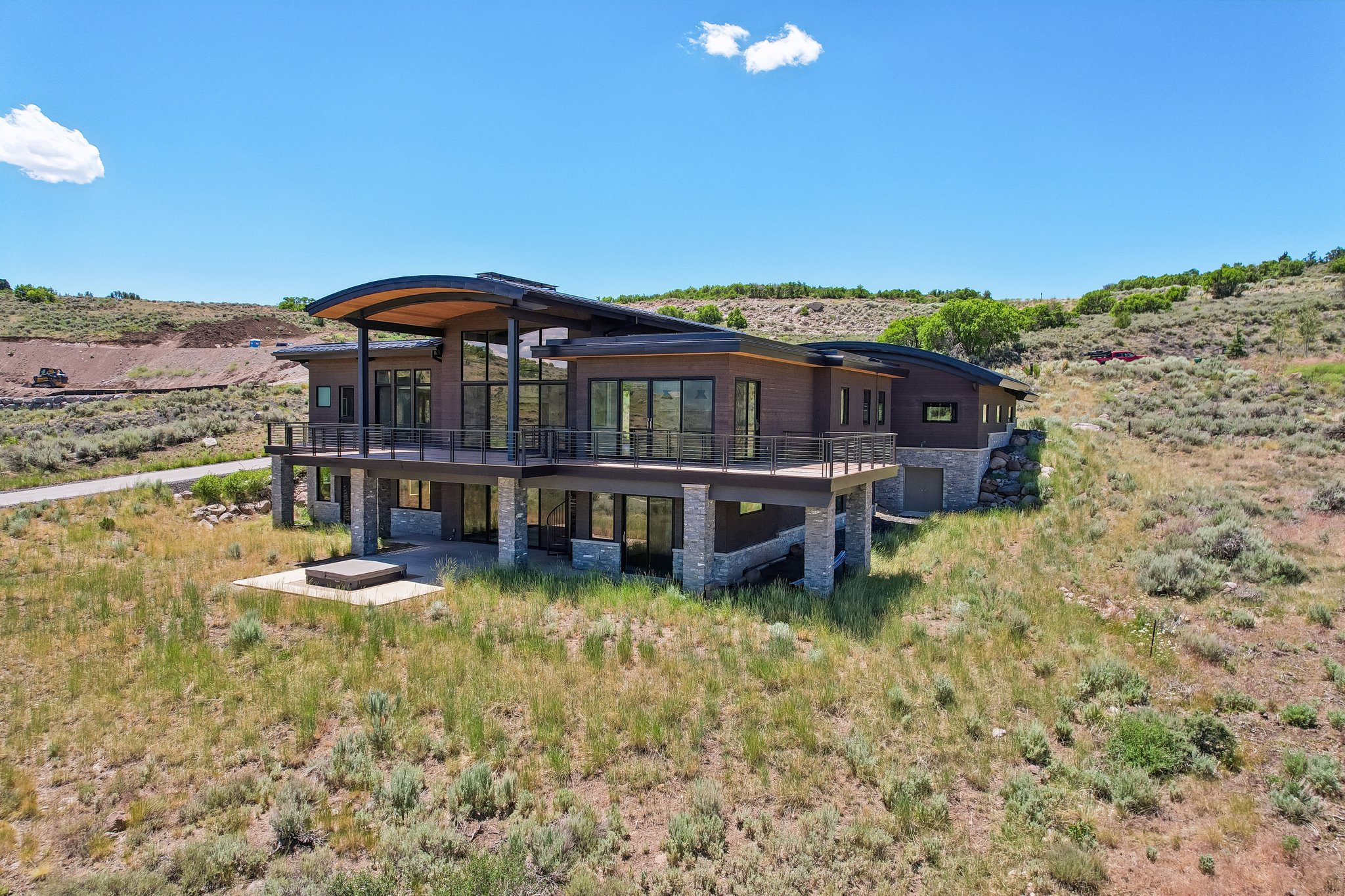 Contemporary architecture featuring a curved roofline and extensive window arrangements