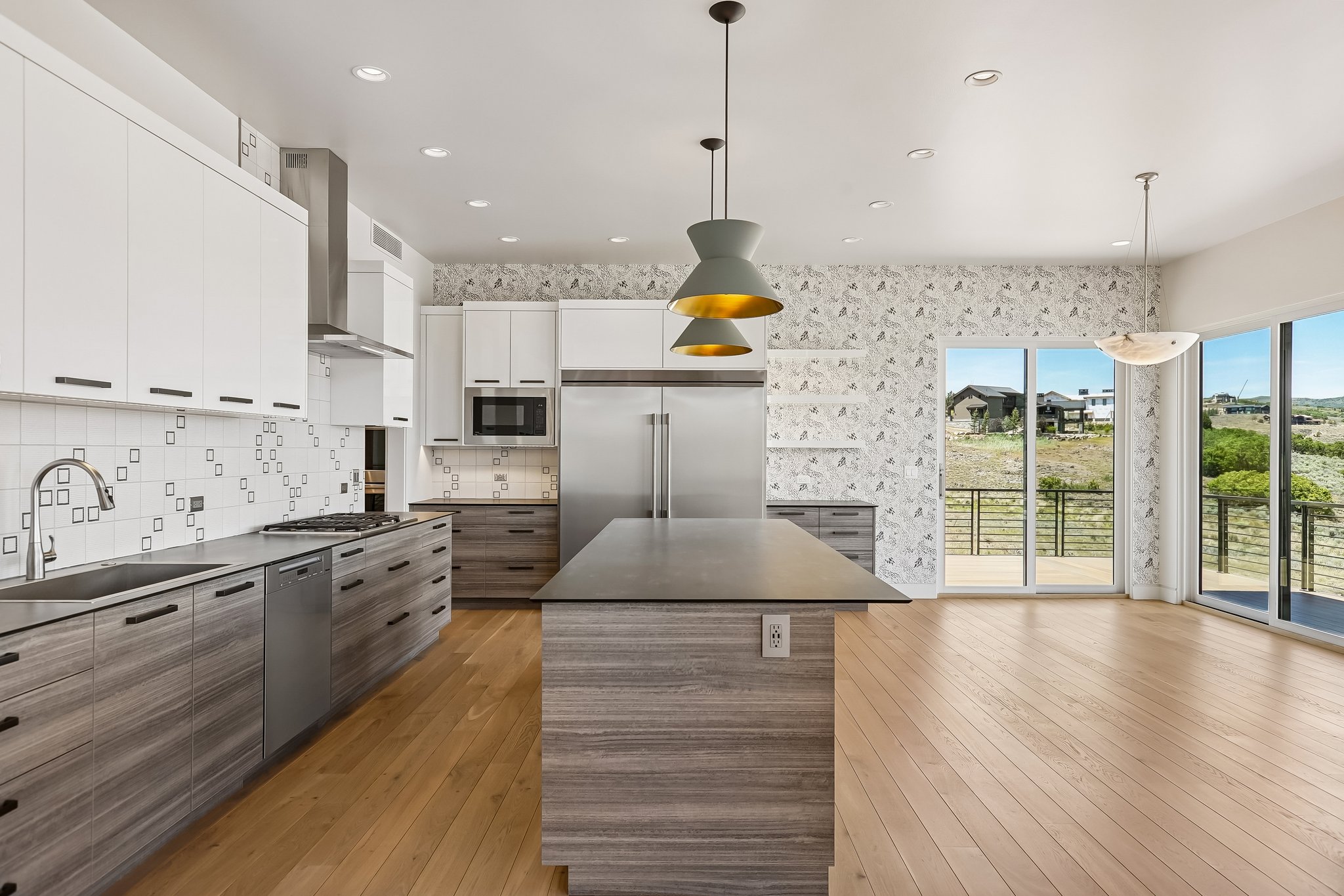 Contemporary kitchen featuring a large central island with a solid surface countertop