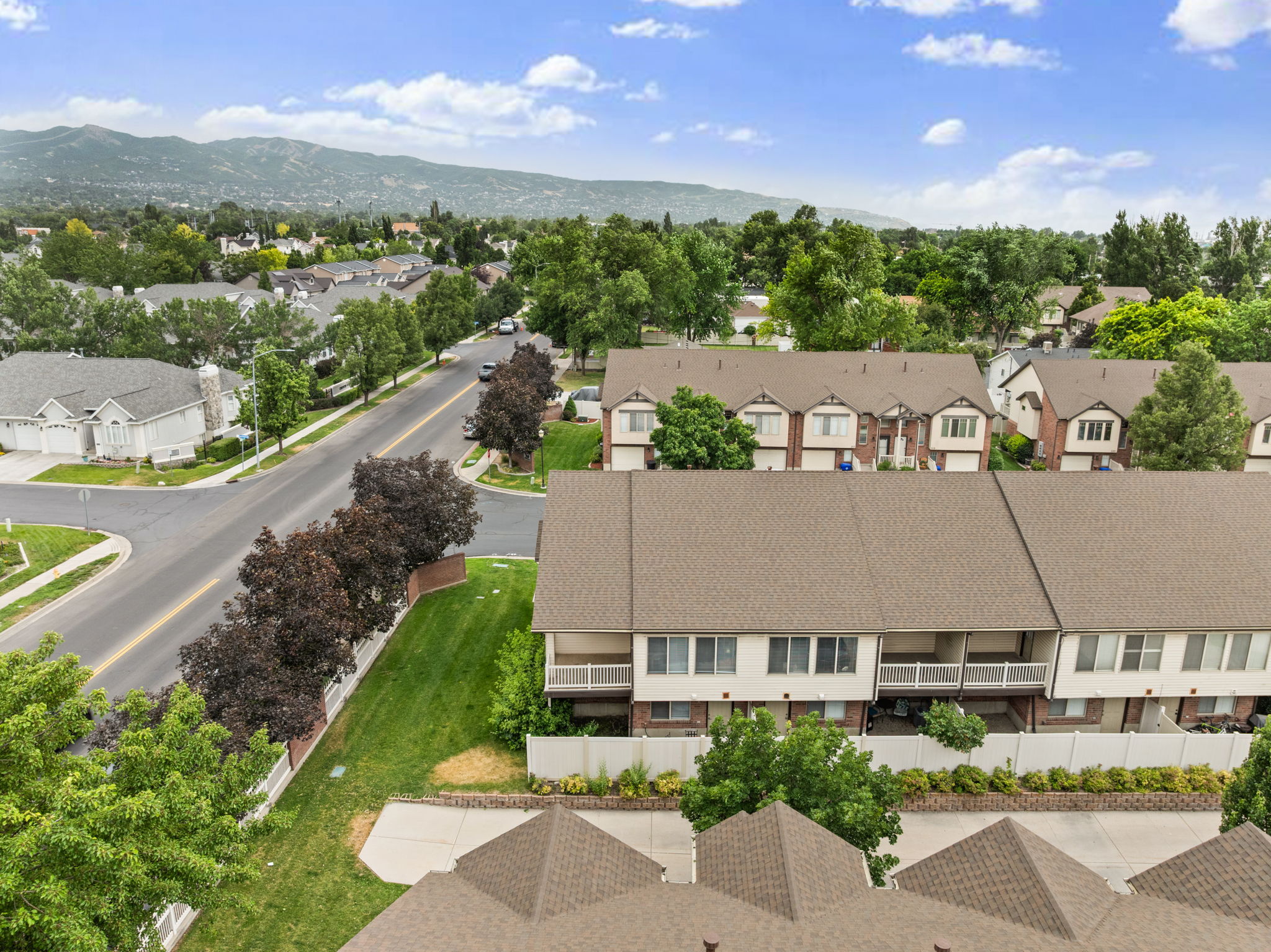 Residential area with established trees and mountain backdrop
