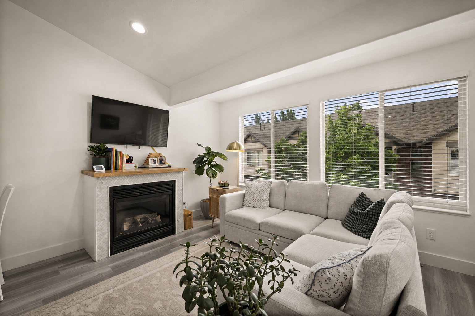 Living area featuring a gas fireplace with a mosaic tile surround and a wood mantel