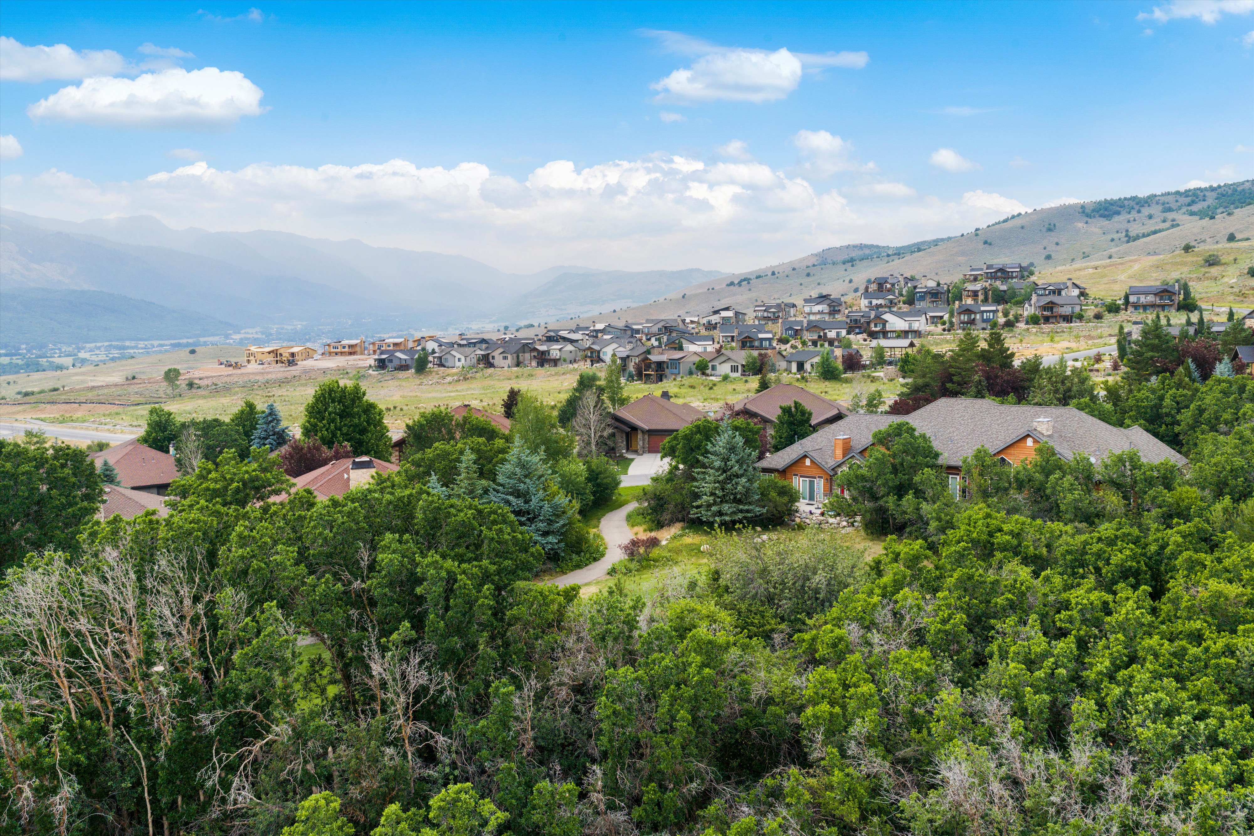 Expansive residential community featuring a variety of architectural styles, mature landscaping, and hillside settings