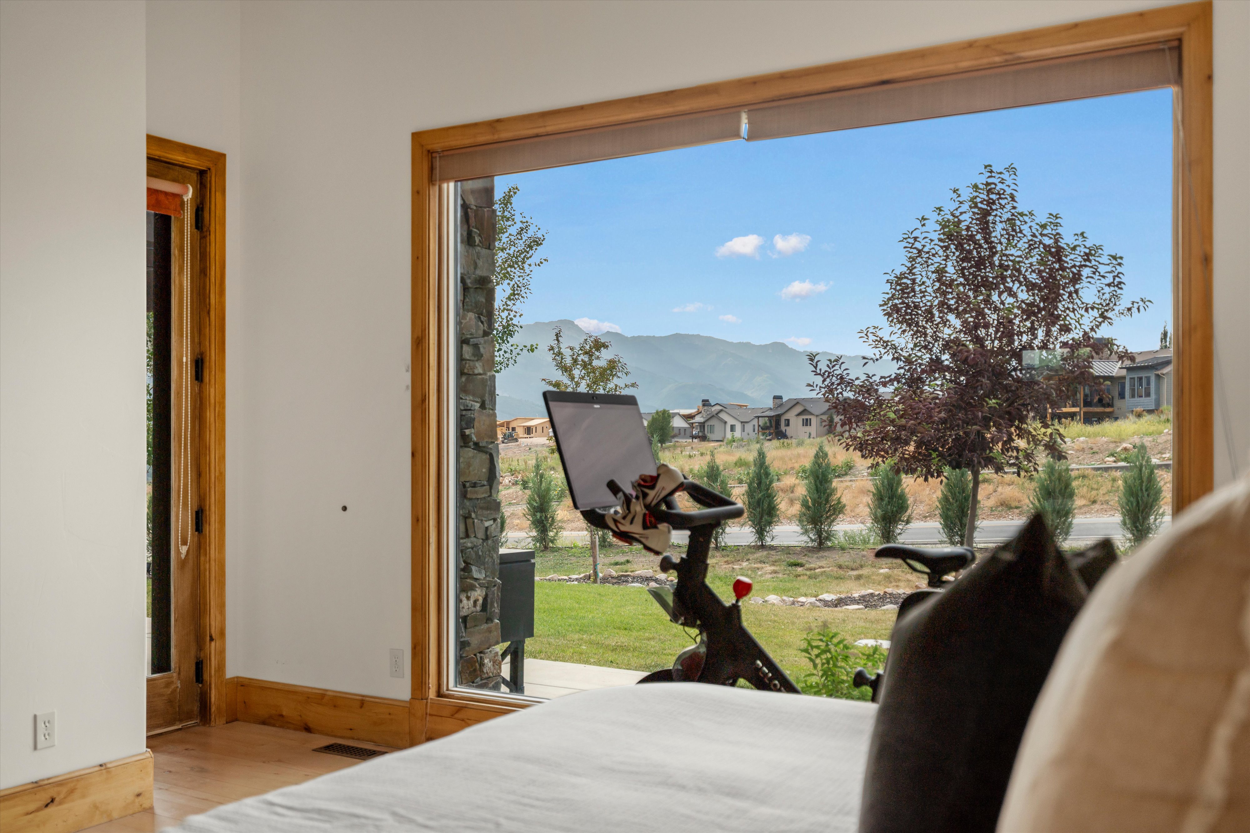 Expansive window featuring natural wood trim and a mountain backdrop