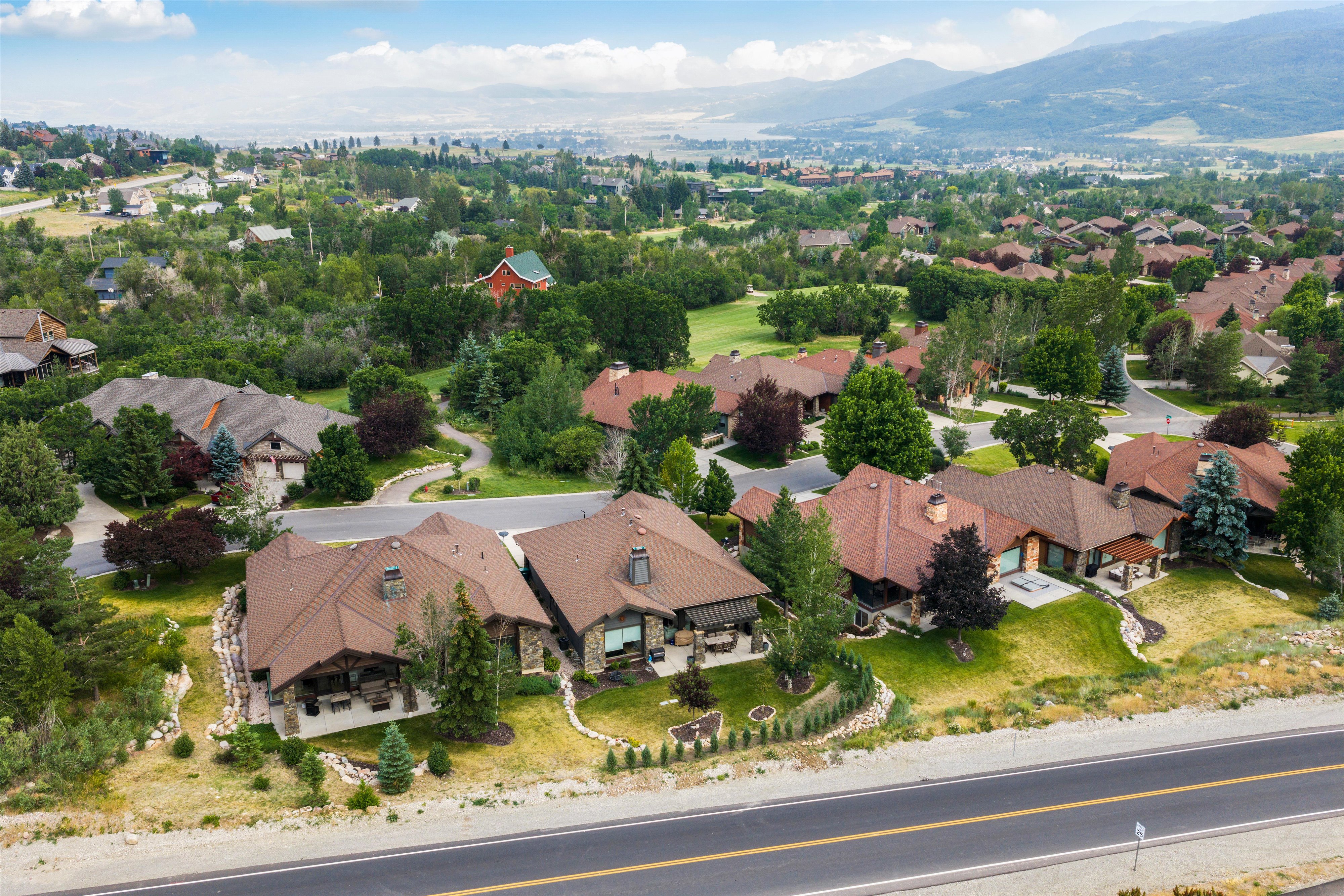 Expansive residential community featuring a variety of architectural styles, mature landscaping, and mountainous surroundings