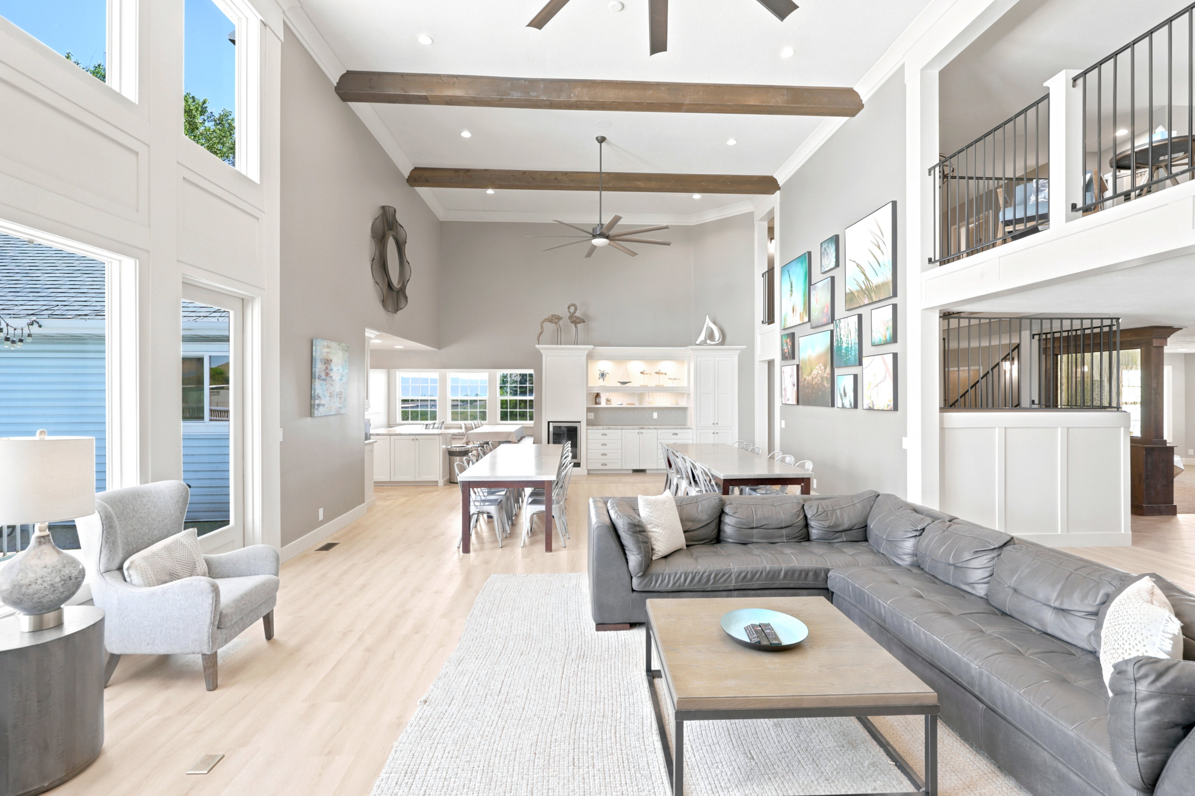 Vaulted ceilings with exposed beams define this open-concept living space