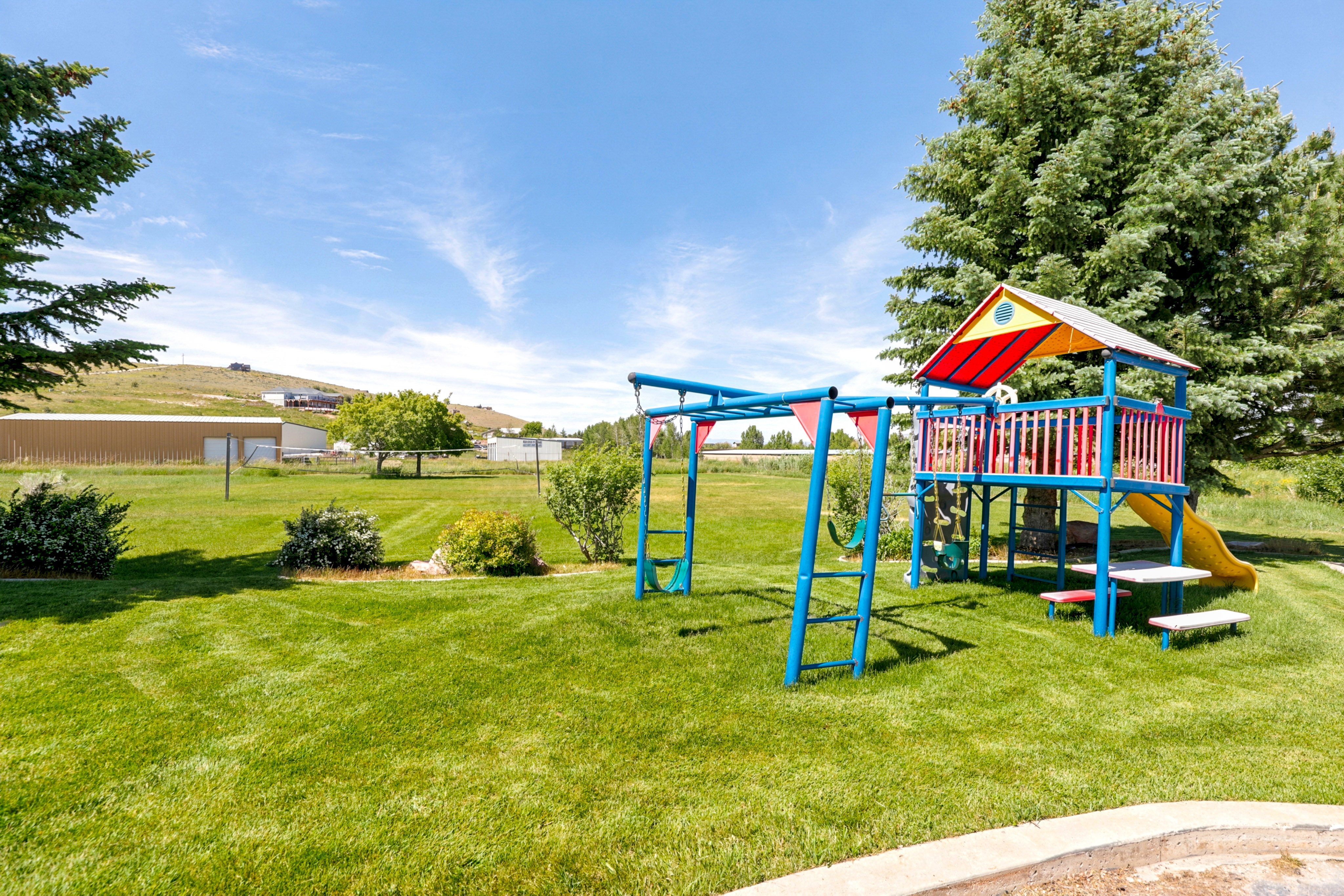 Expansive green lawn with established trees and shrubbery