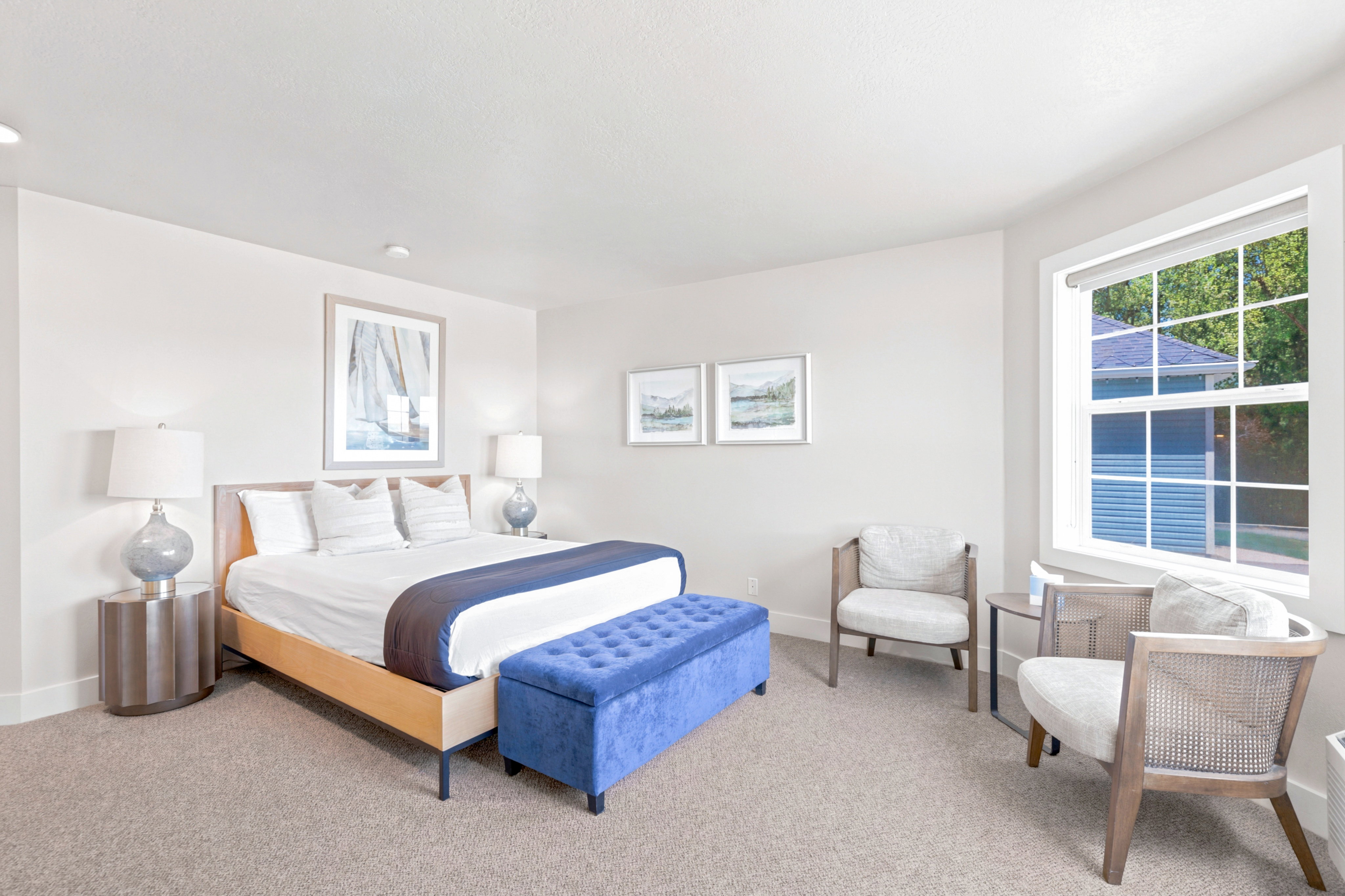 Carpeted room featuring a large window with white trim, recessed lighting, and neutral wall paint
