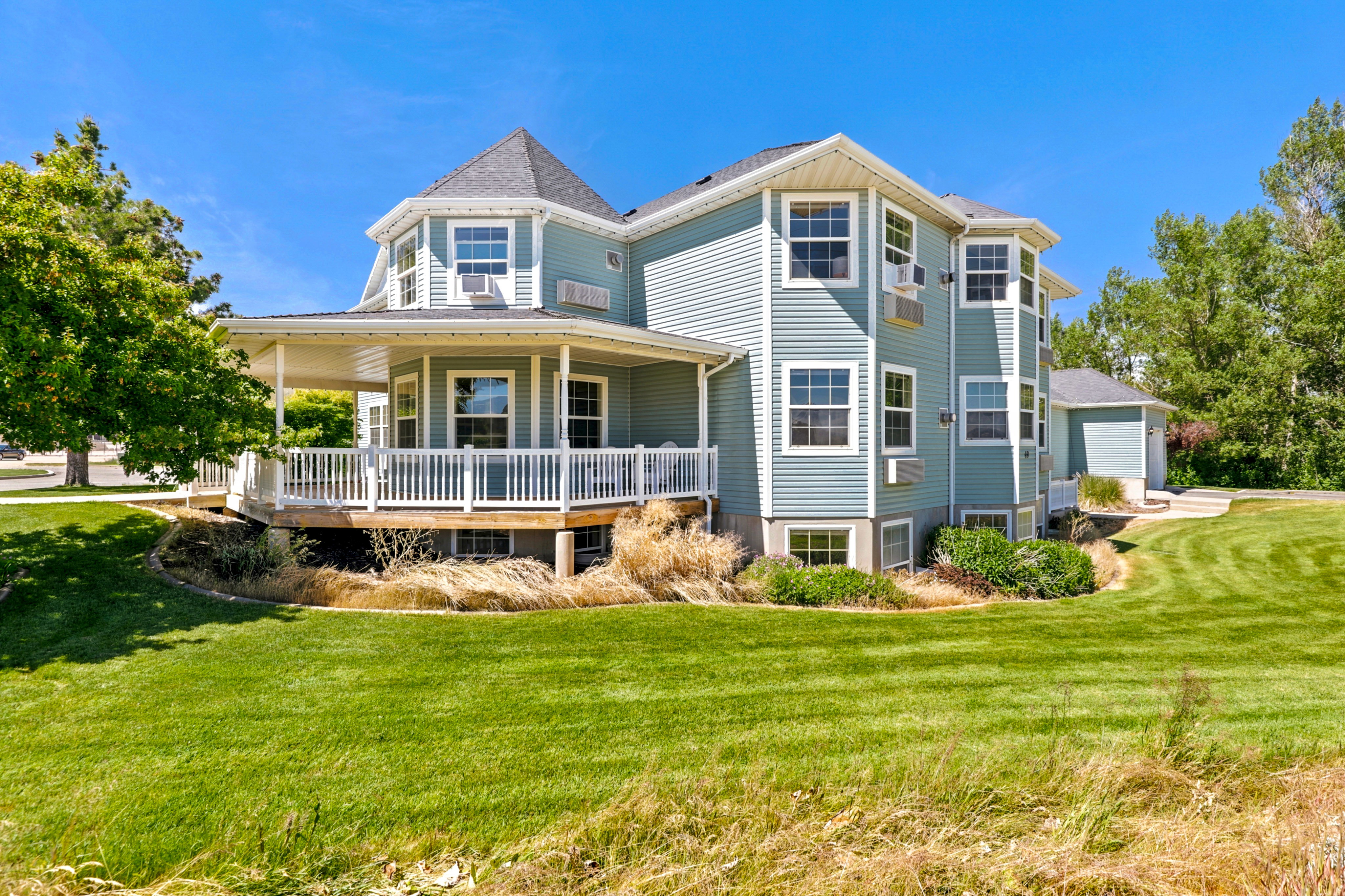 Multi-level property with light blue horizontal siding and white trim