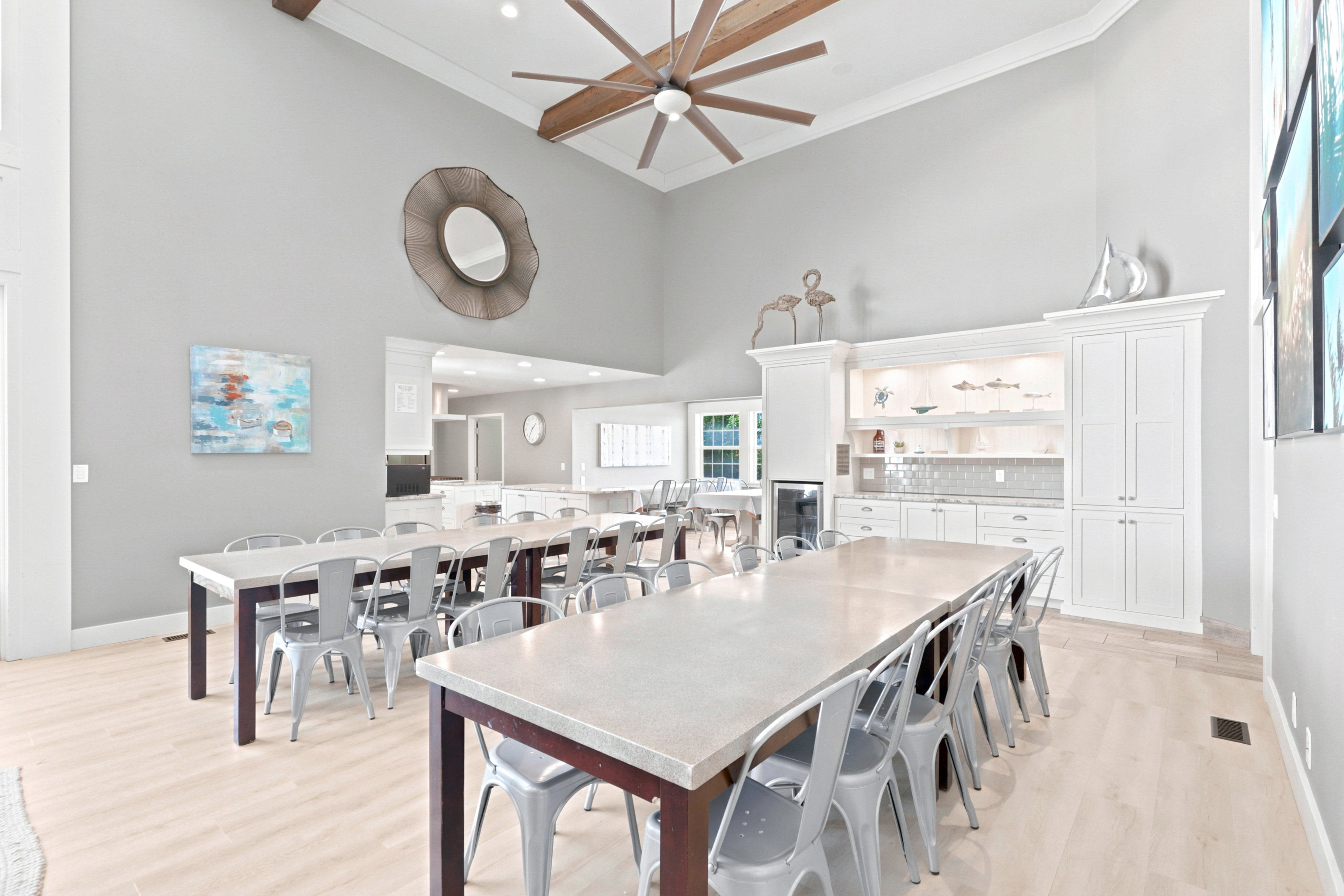 Vaulted ceilings with exposed beams and a large ceiling fan