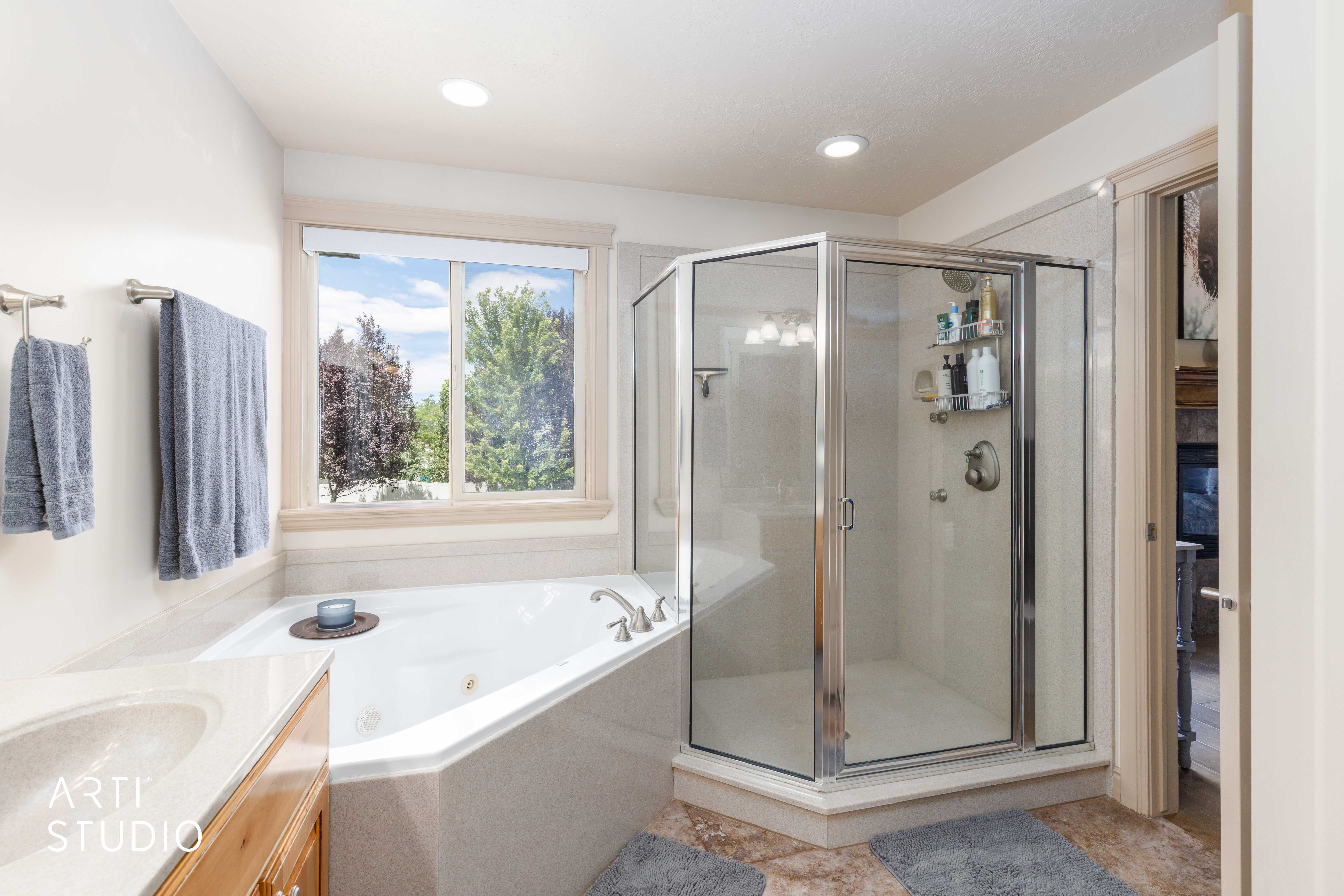Primary ensuite bathroom with jetted tub and separate shower