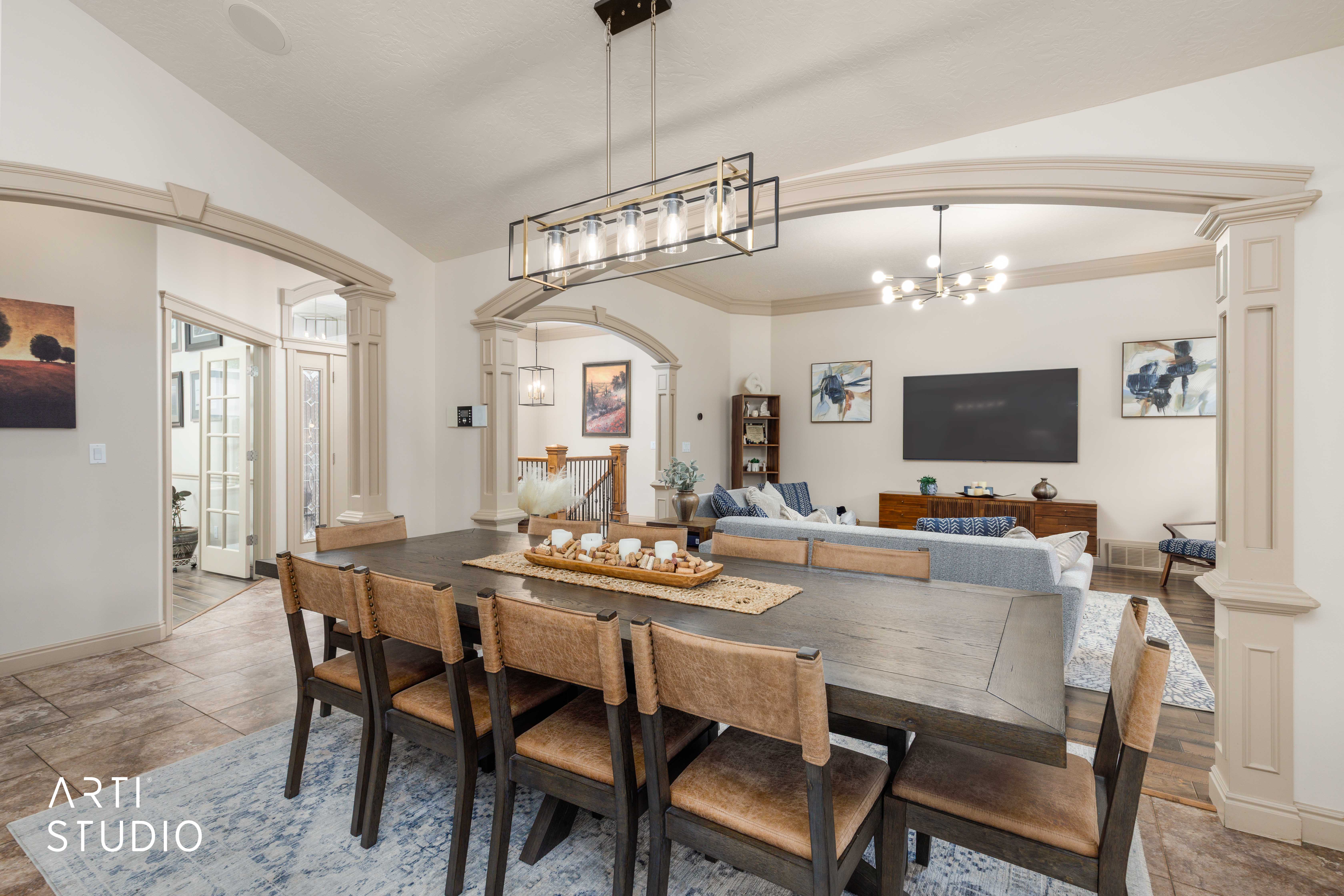 Open concept living, dining and kitchen. French doors lead to a covered deck overlooking backyard