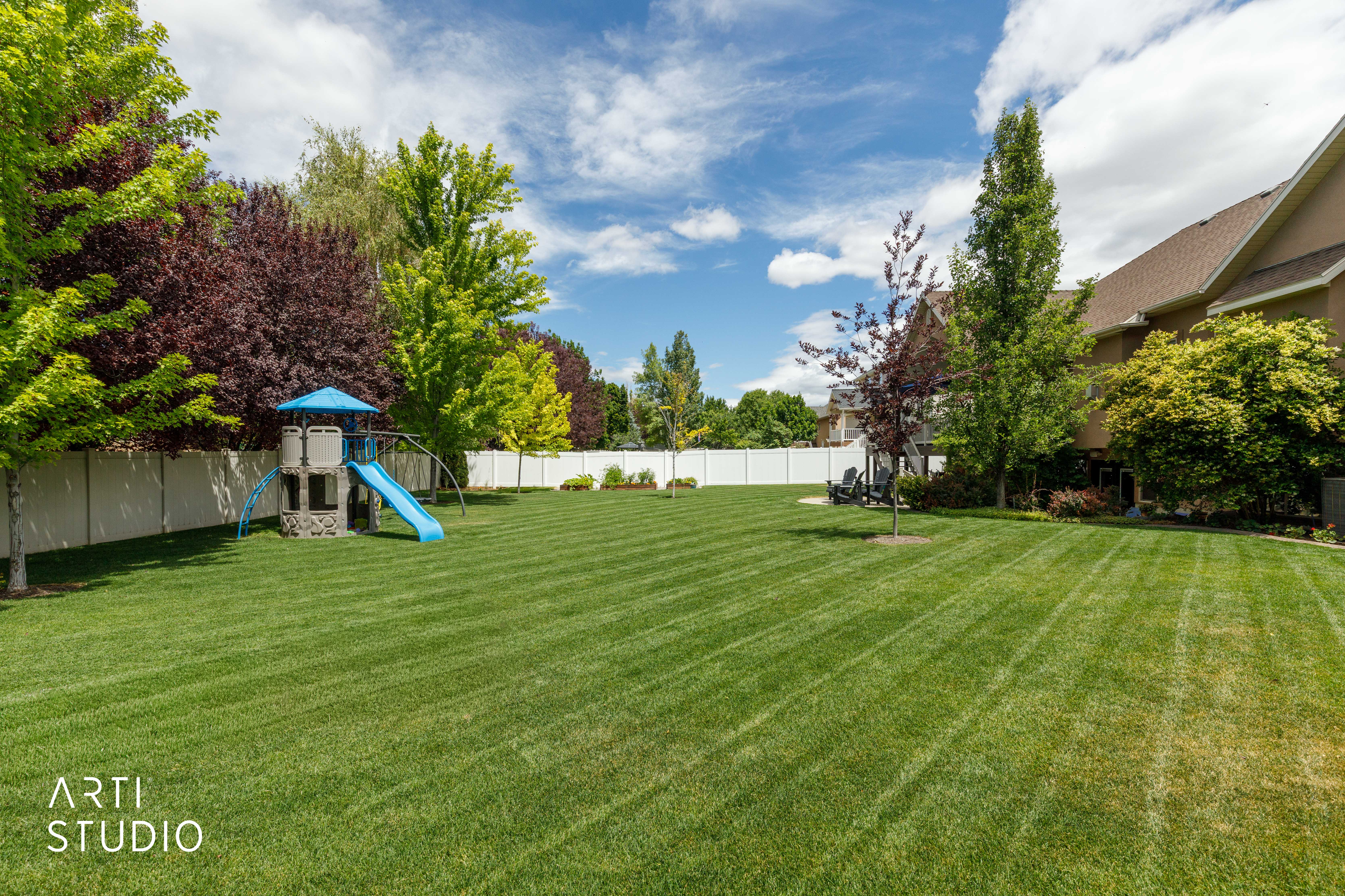 Expansive flat yard surrounded by mature trees